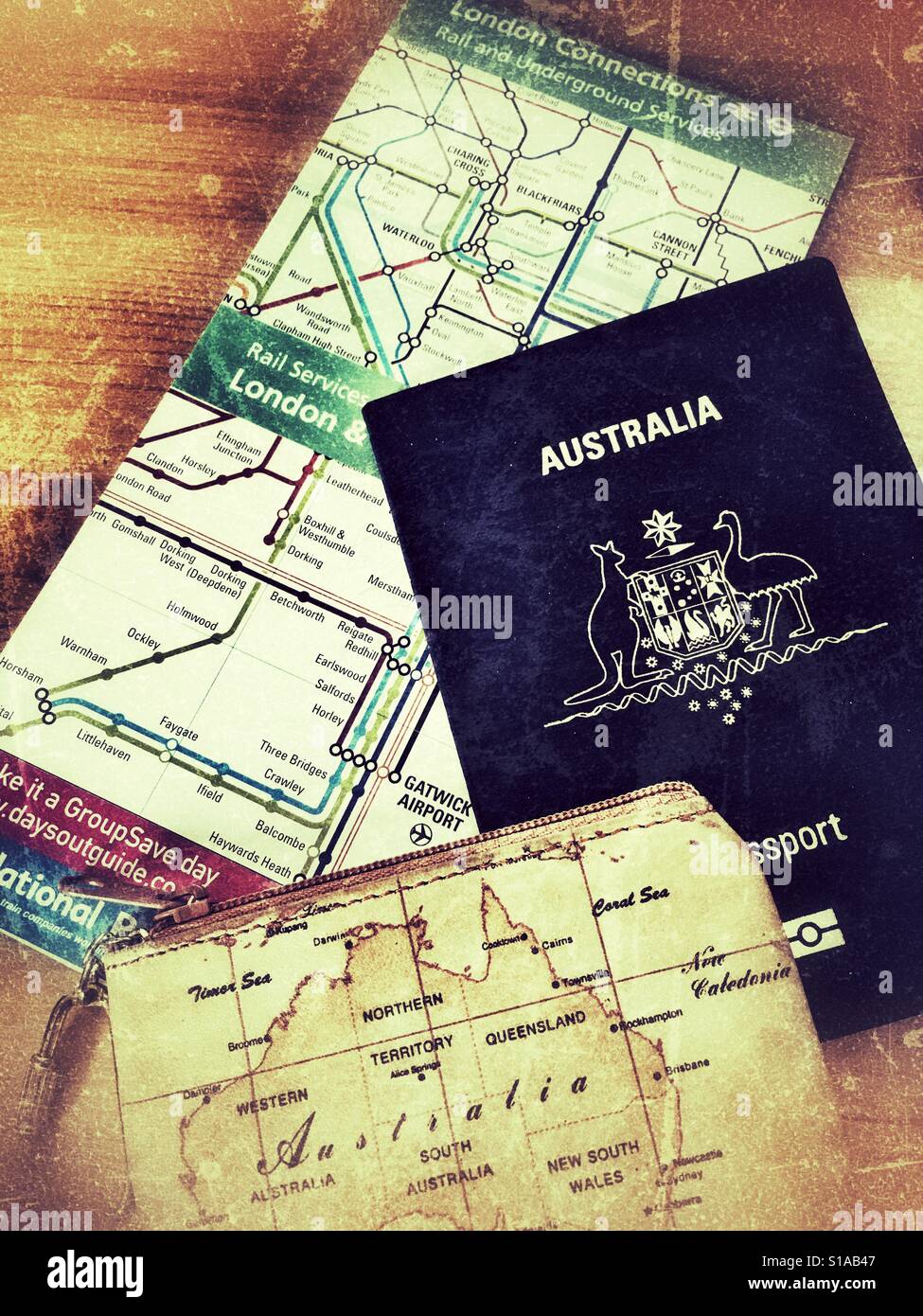 Travel. Australian passport, purse and London Connections and Underground map - Smartphone Captured Stock Image
