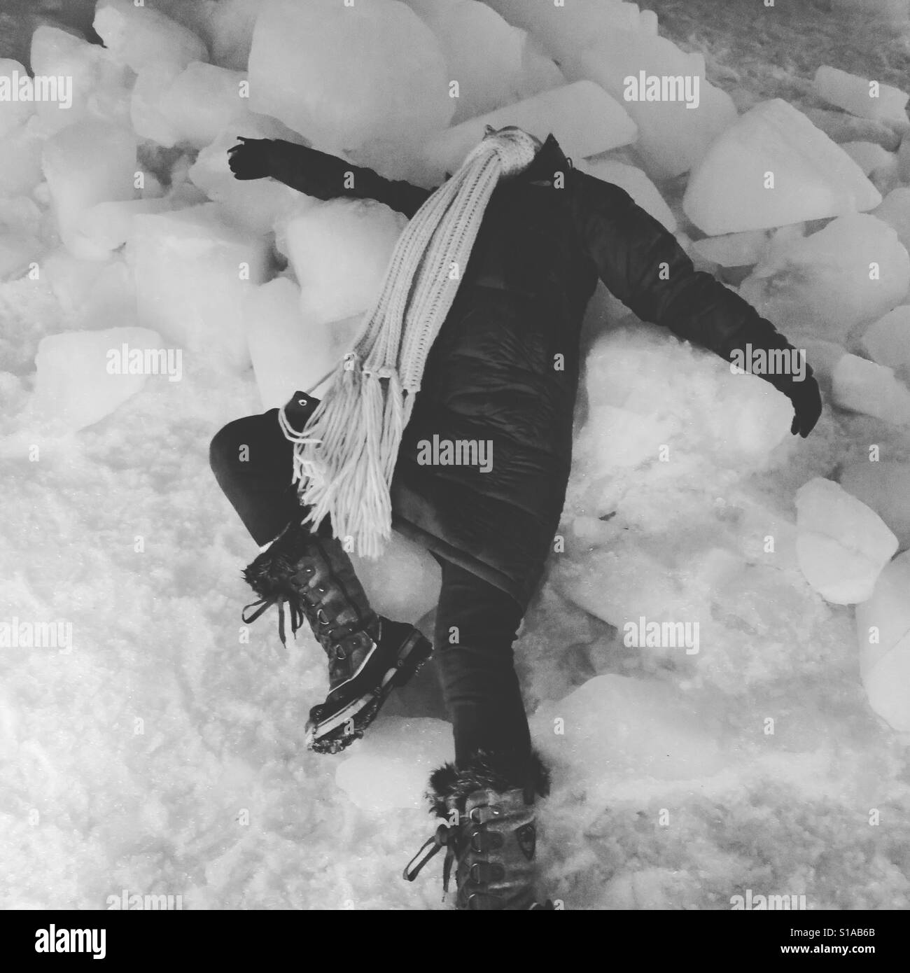Lying on ice blocks, Iceland Stock Photo