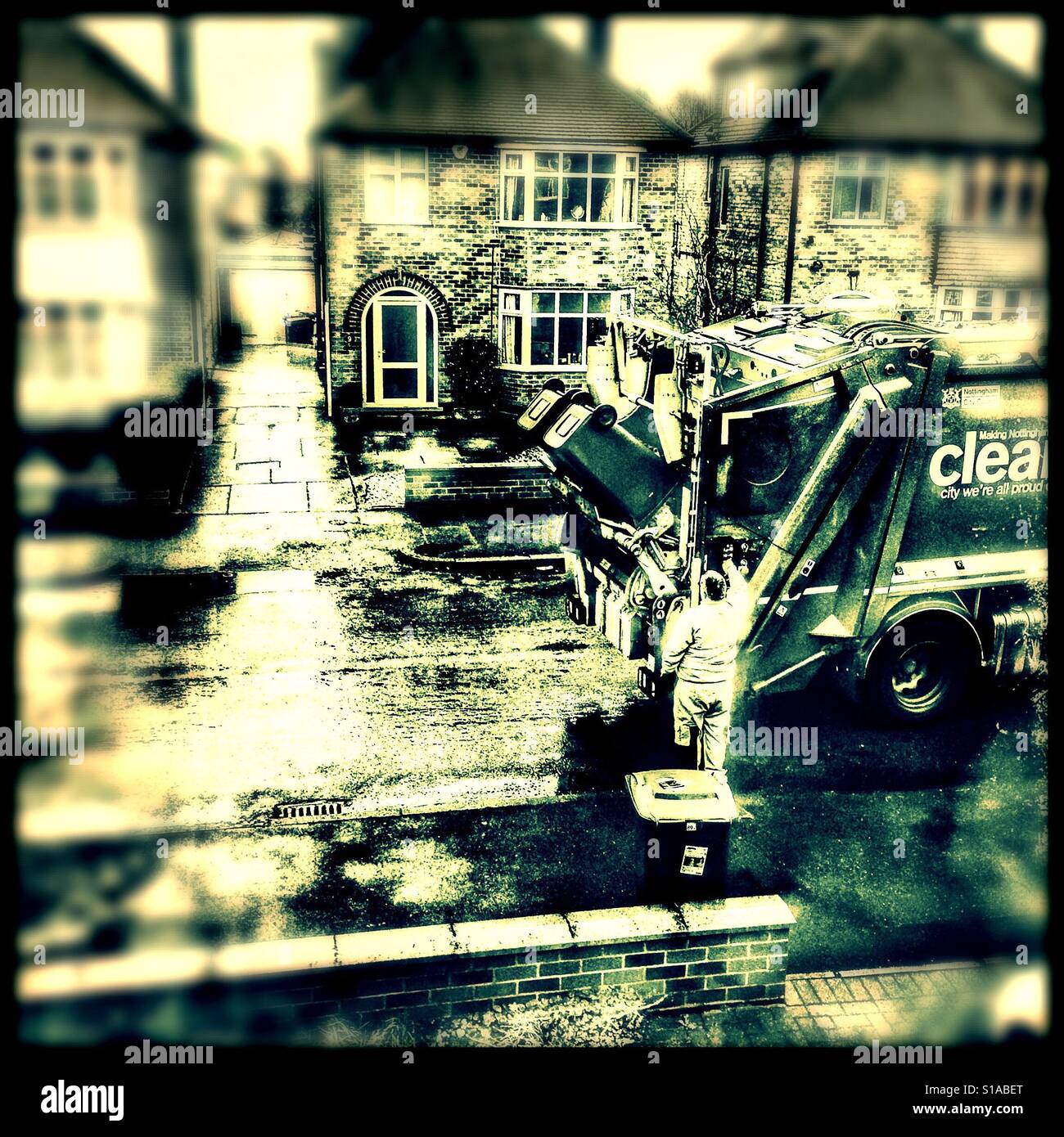 Rubbish track emptying bins in residential street, Nottingham, England - Smartphone Captured Stock Image