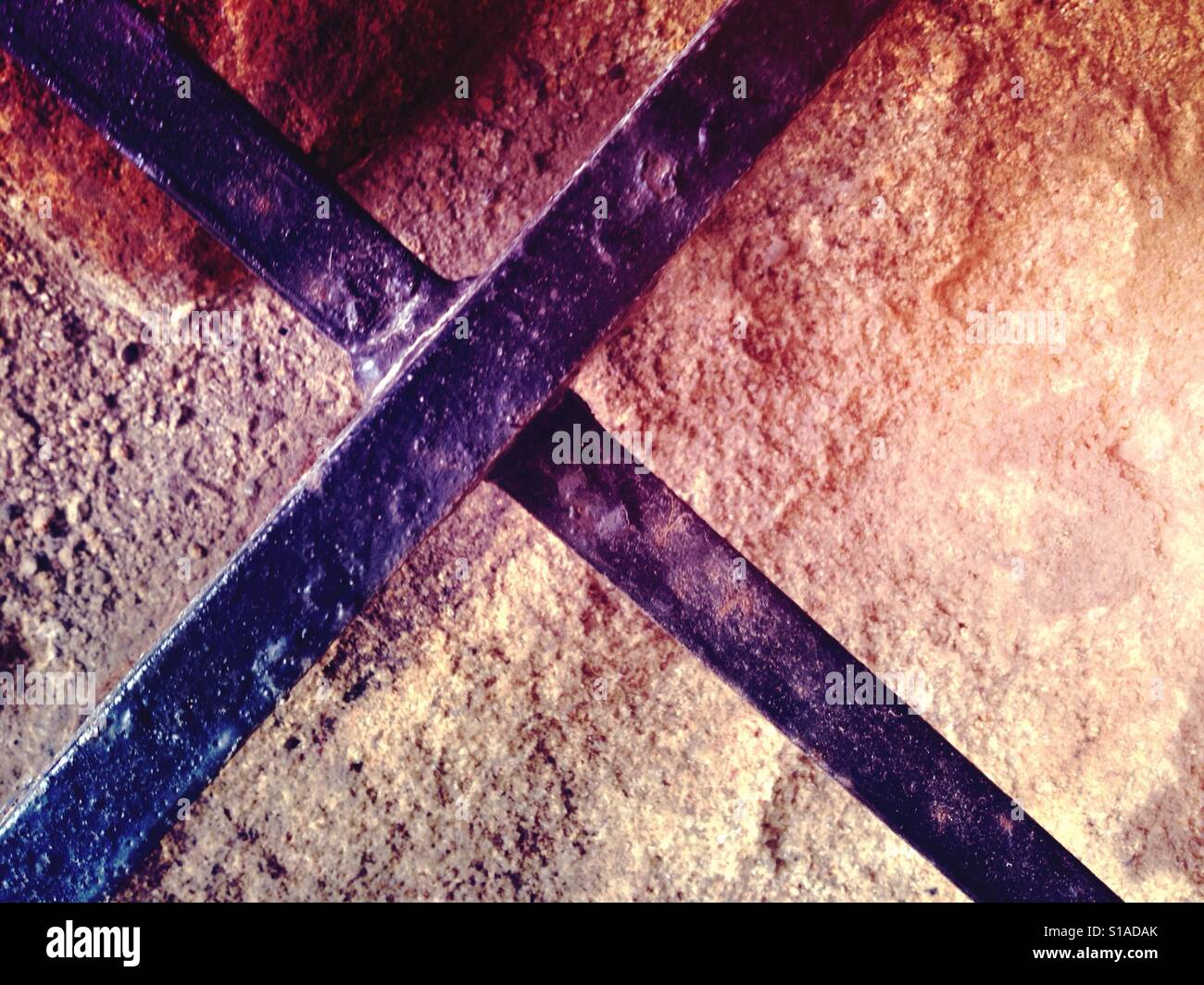 Metal cross on stone - Smartphone Captured Stock Image