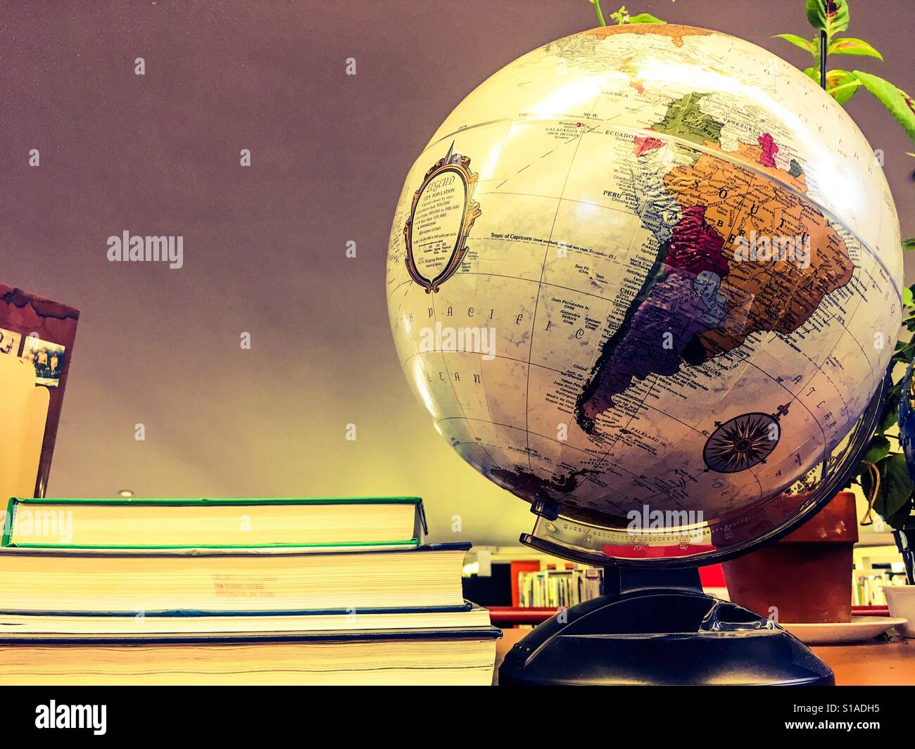 Globe and books Stock Photo - Alamy