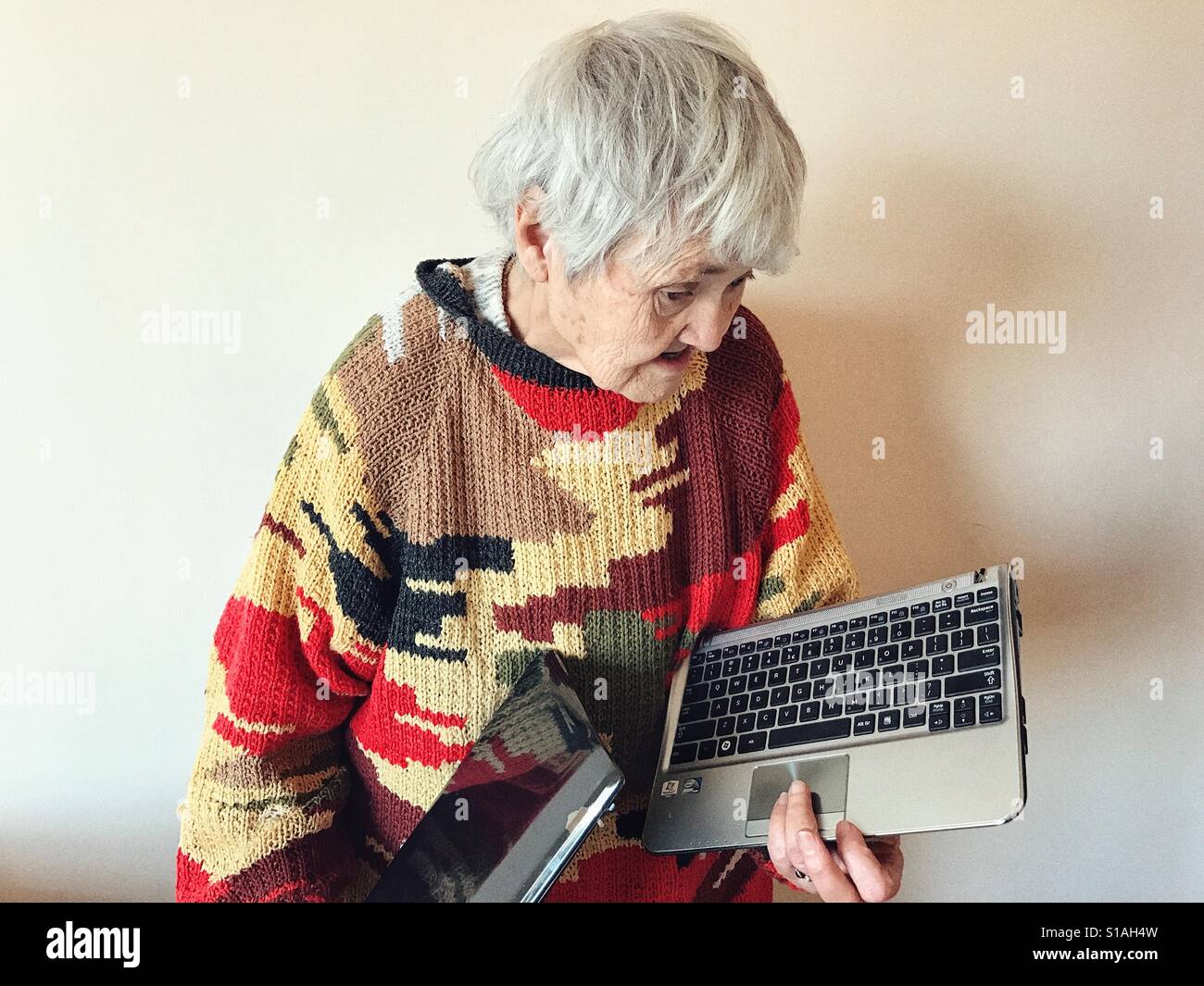Senior woman and broken laptop Stock Photo