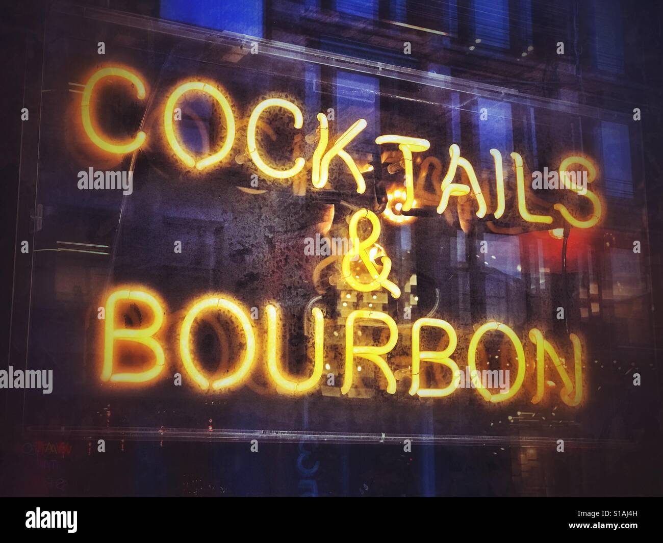A bright yellow neon Cocktails & Bourbon sign Stock Photo Alamy