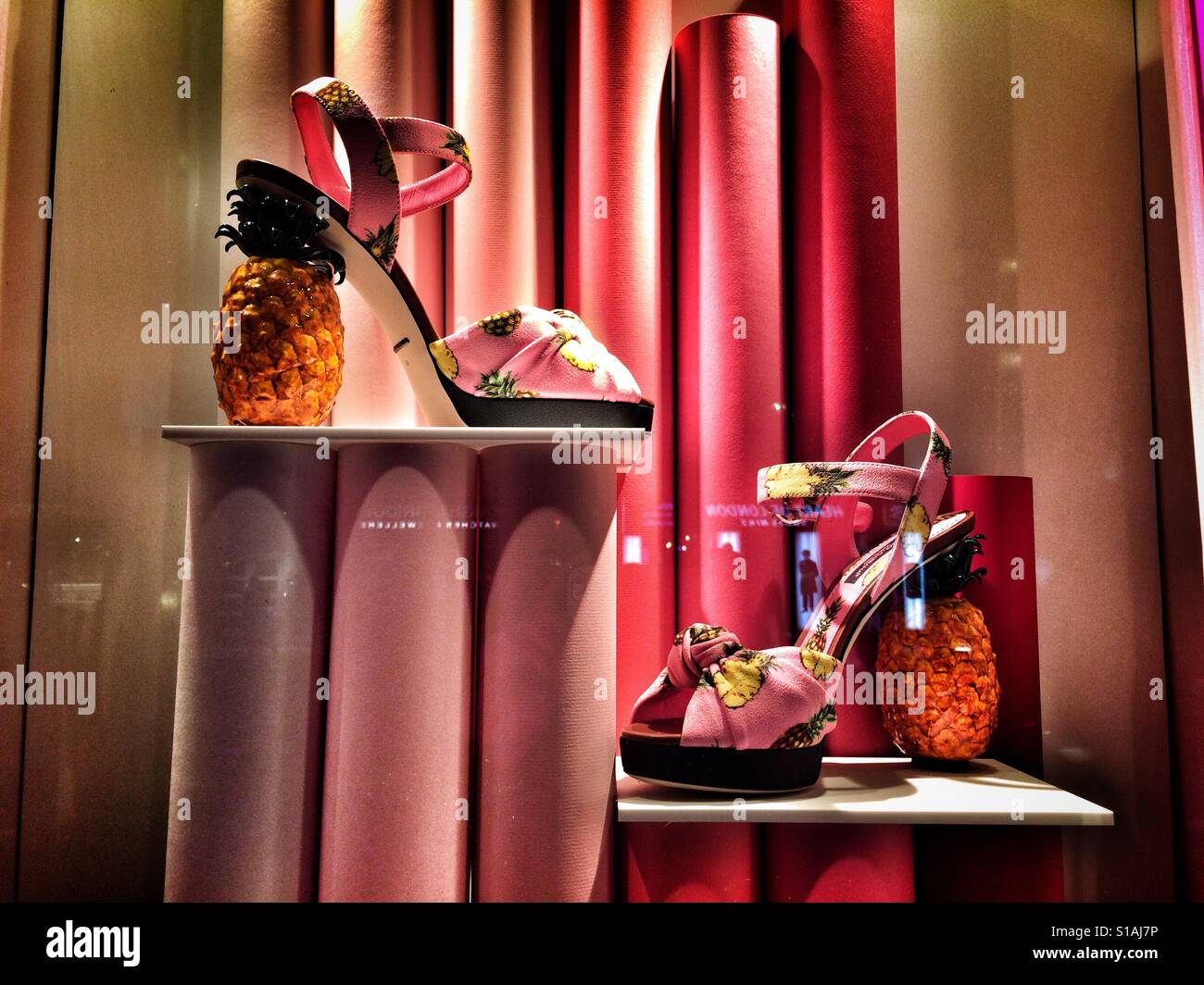 Eccentric pineapple heeled shoes on display in a shop window - Smartphone Captured Stock Image