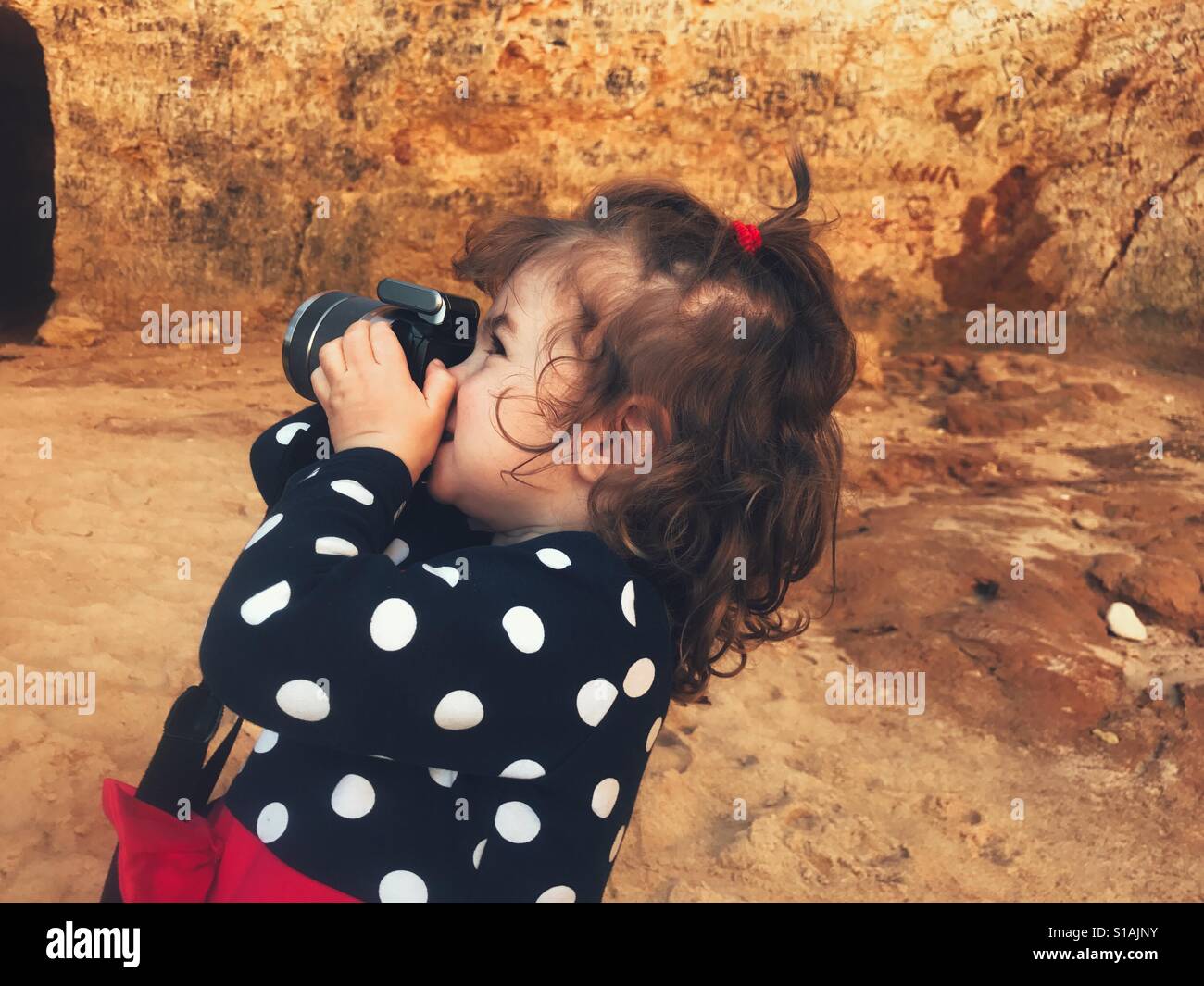 Little girl holding a camera Stock Photo