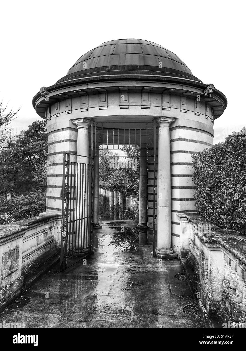 Black and white photo of a domed structure on the Pergola in the Hill Garden on a rainy afternoon at West Heath, Hampstead Heath, London, England, UK. Stock Photo