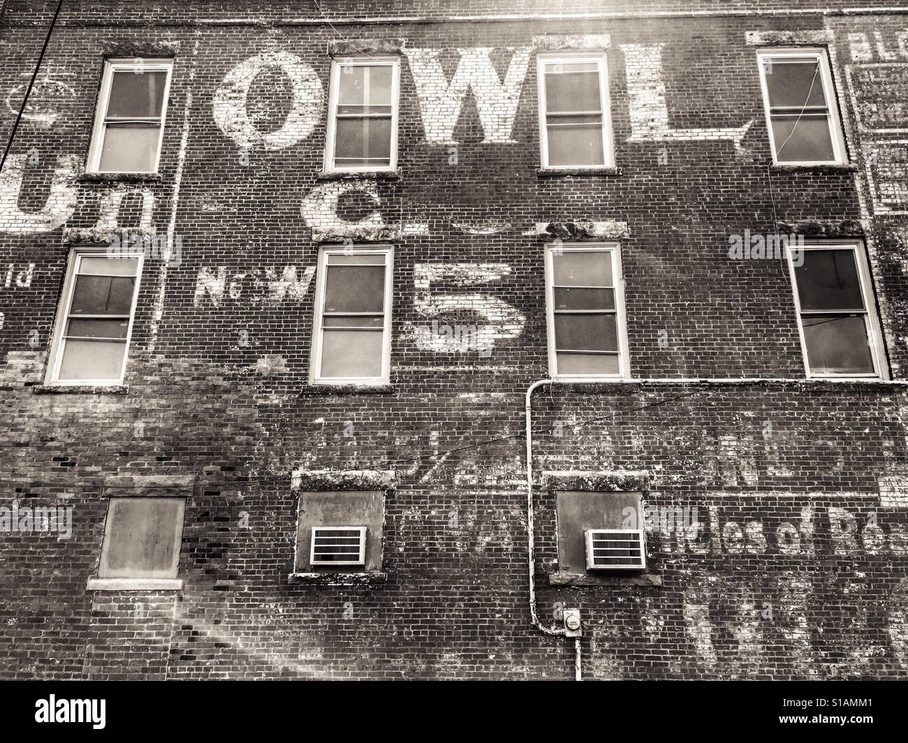 Old Advertising on Side of Brick Building Stock Photo