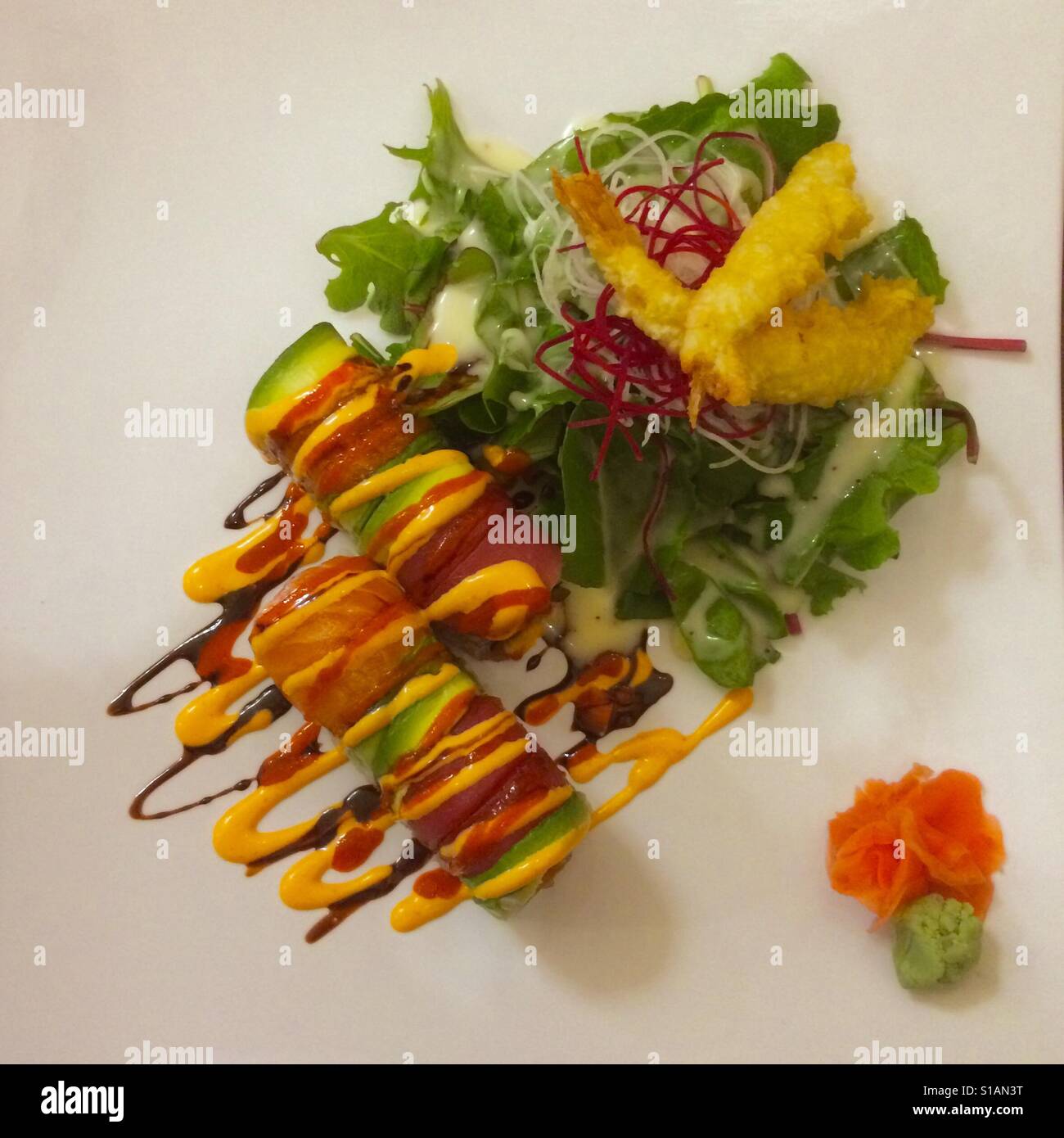 Sushi, colorful salmon and avocado roll, served with salad, wasabi and pickled ginger - Smartphone Captured Stock Image