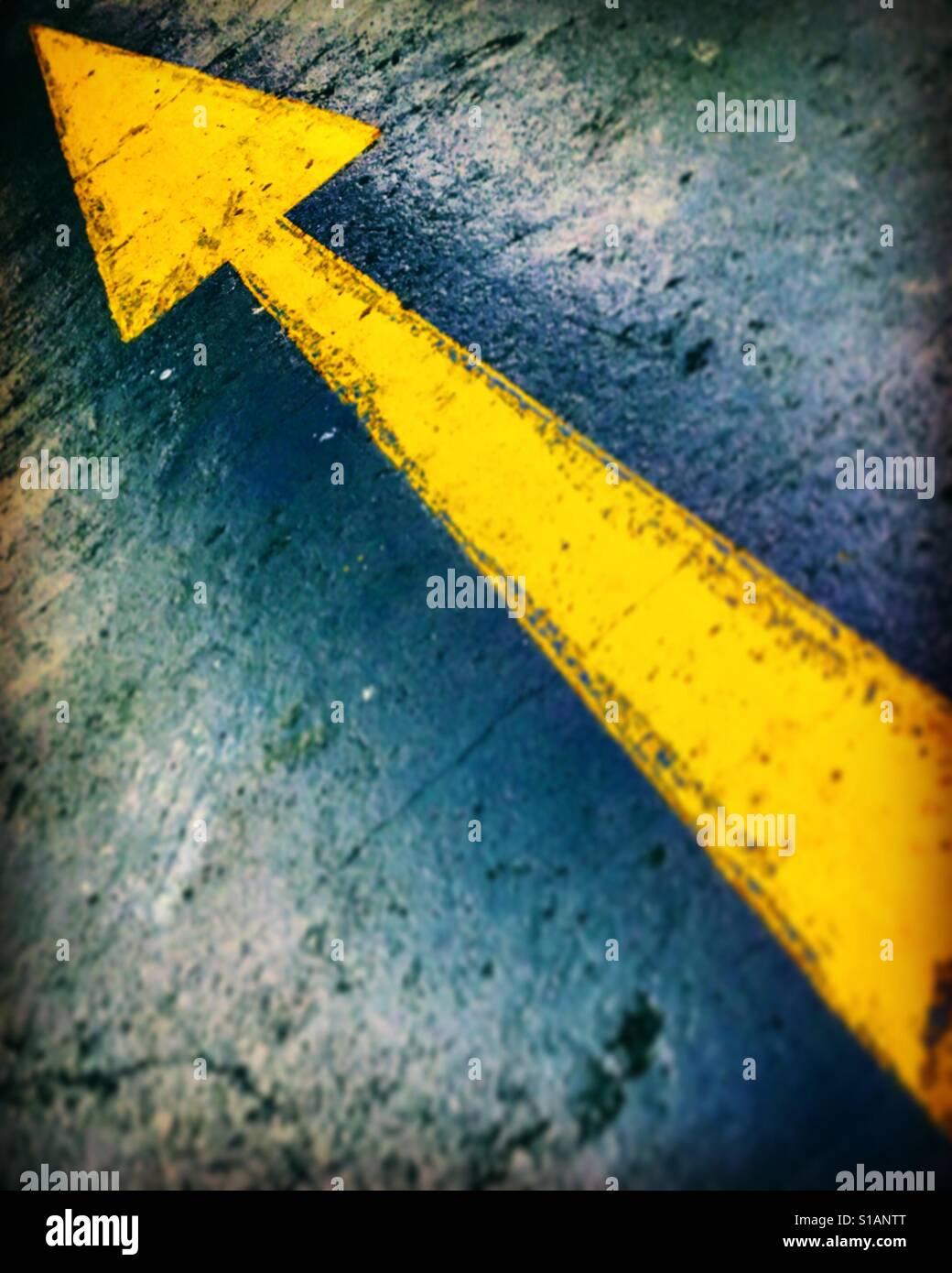 Yellow arrow pointing top left - Smartphone Captured Stock Image