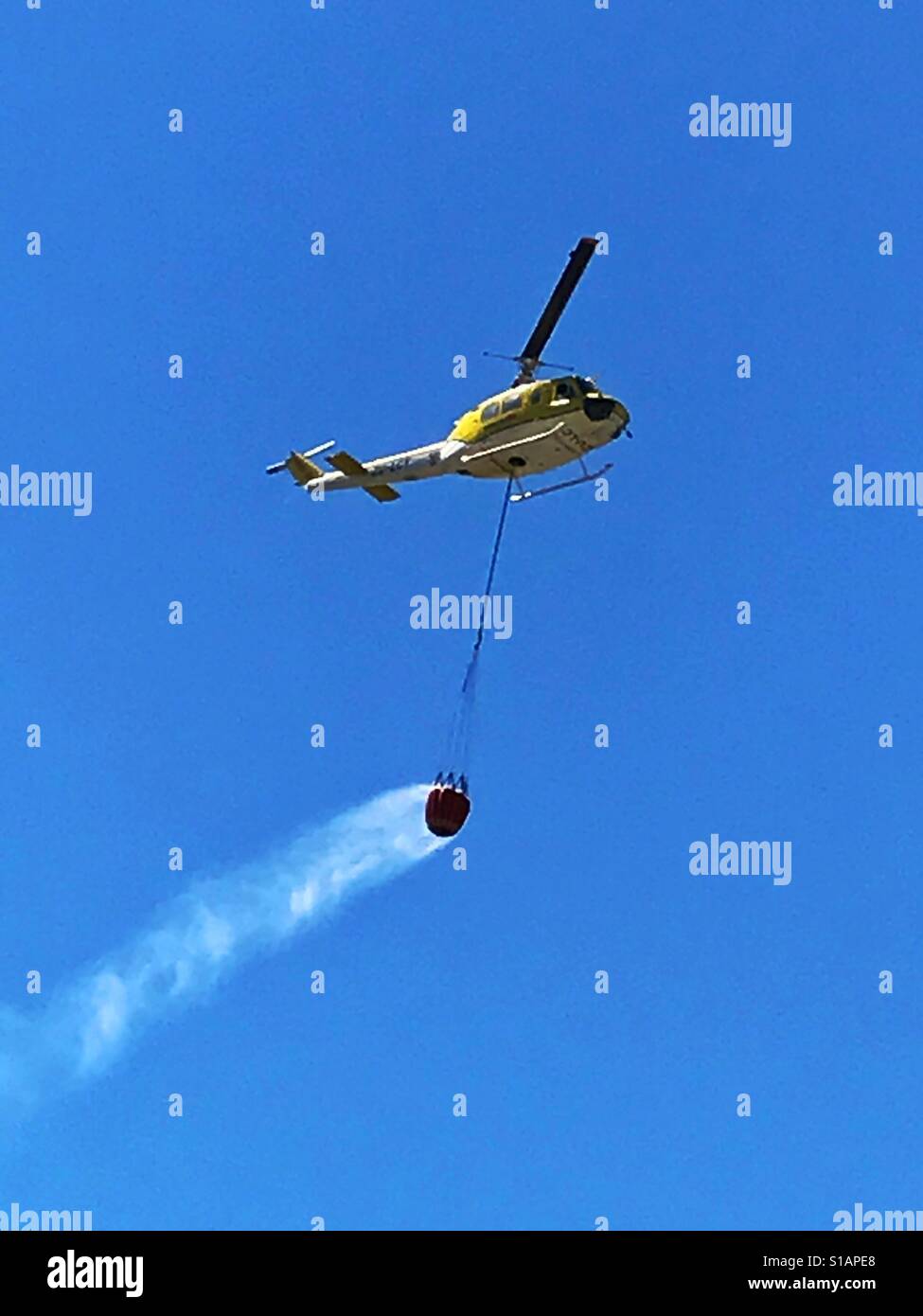 Helicopter putting out fire on Table Mountain, Cape Town, South Africa. - Smartphone Captured Stock Image