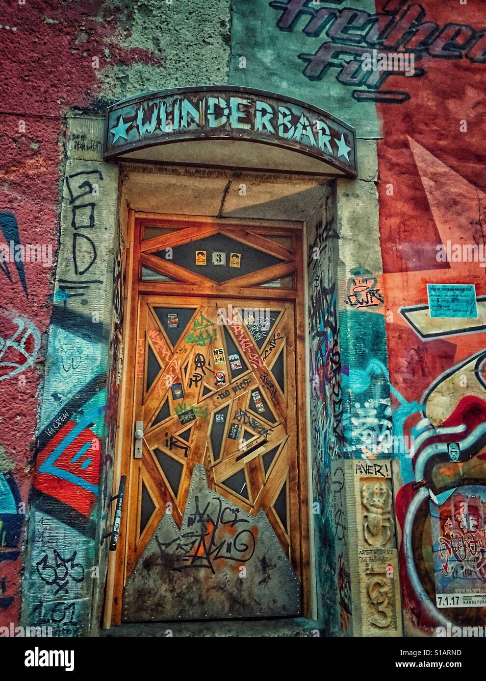 Wunderbar / Wonderful , written in german language over an underground door and street art all