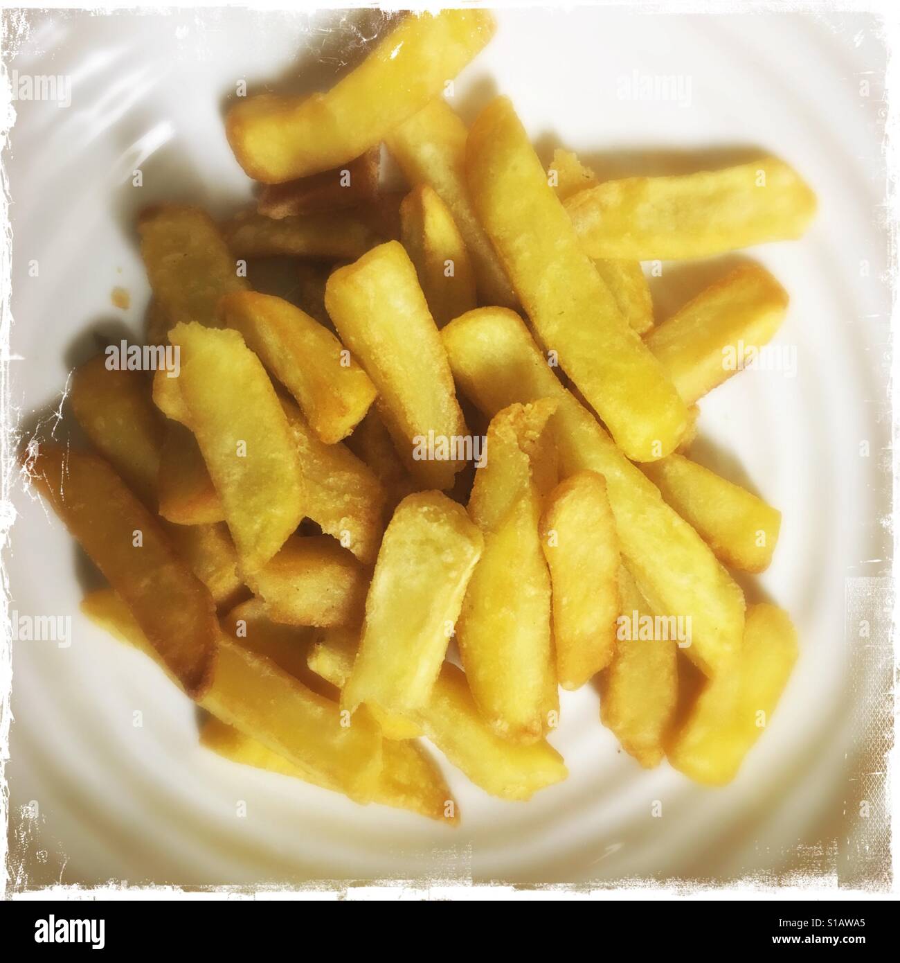 Bowl of golden coloured chips Stock Photo