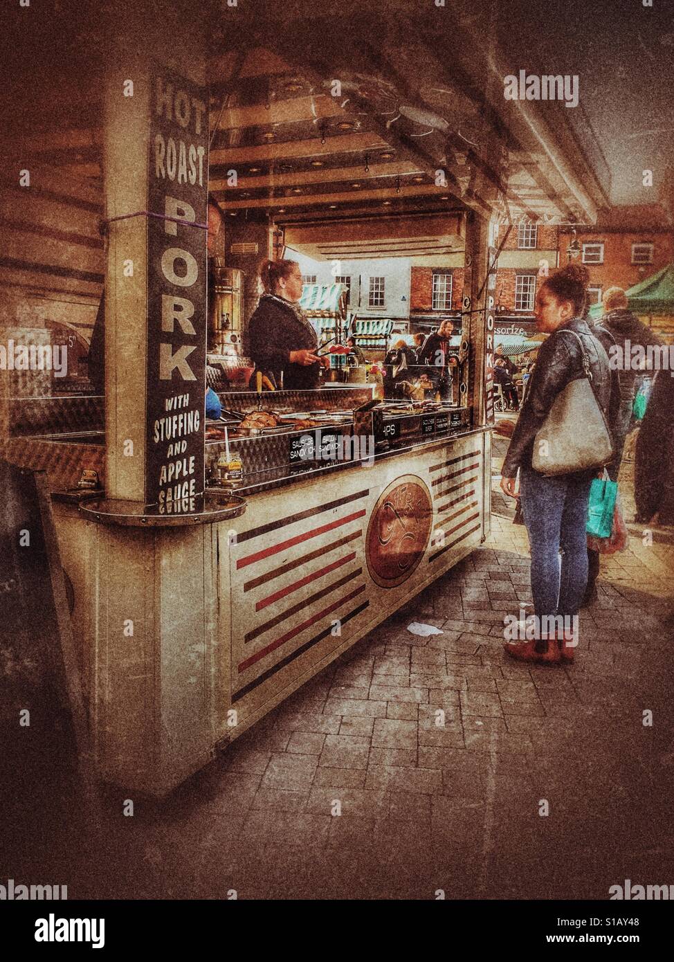 Girl looking at food on a Bugger bar in the Saturday market in Beverley in the East Riding of Yorkshire - Smartphone Captured Stock Image