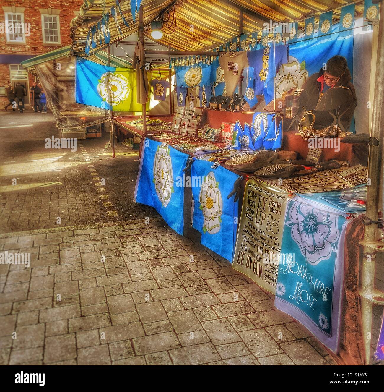 Yorkshire flags on sale in Beverley Saturday market - Smartphone Captured Stock Image