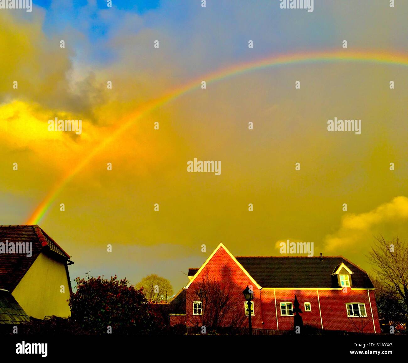 Rainbow clouds rain sun blue sky hi-res stock photography and images ...