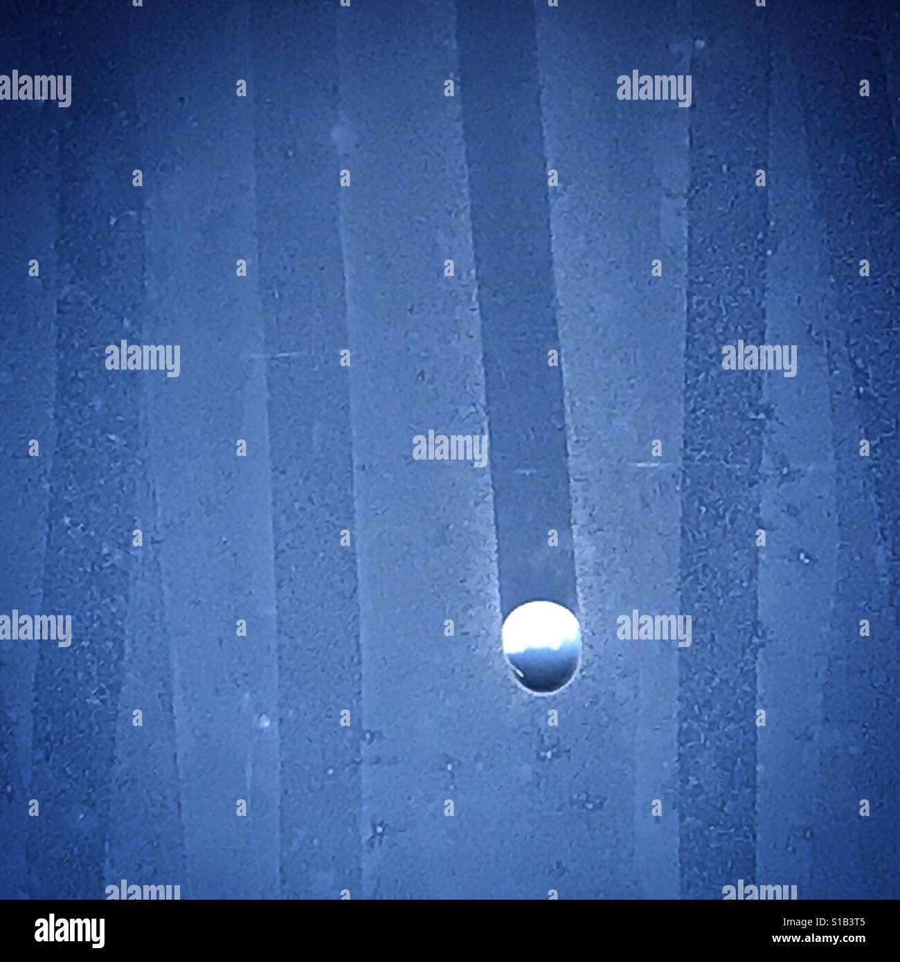 The sky inverted in a drop of water in a plane's window over the Atlantic Ocean - Smartphone Captured Stock Image