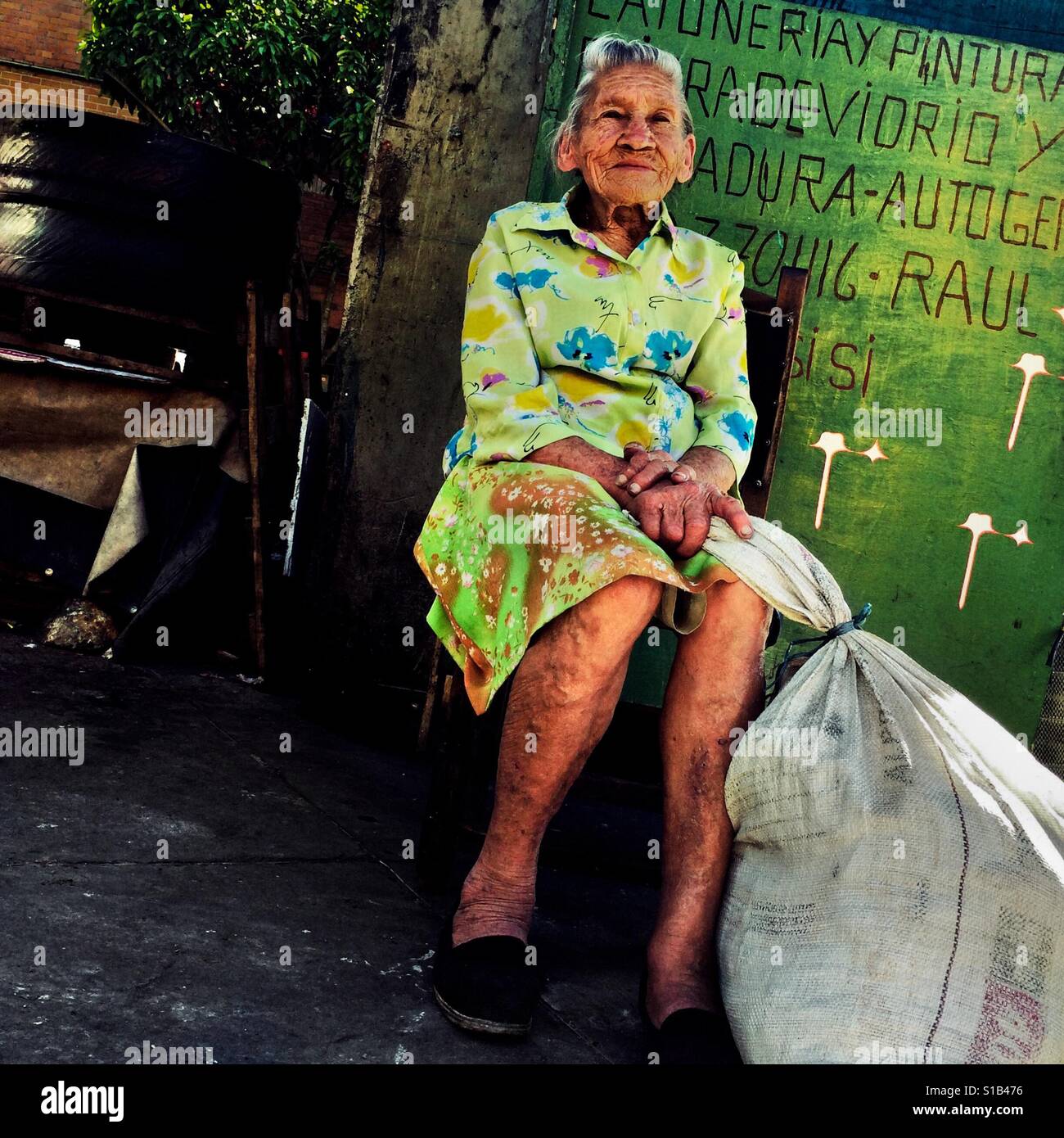 Julia Rosa Cardoña, an 88-years-old Colombian woman, poses for a picture on the street of Barrio Triste, a neighborhood in the center of Medellín, Colombia, 21 November 2016. Stock Photo