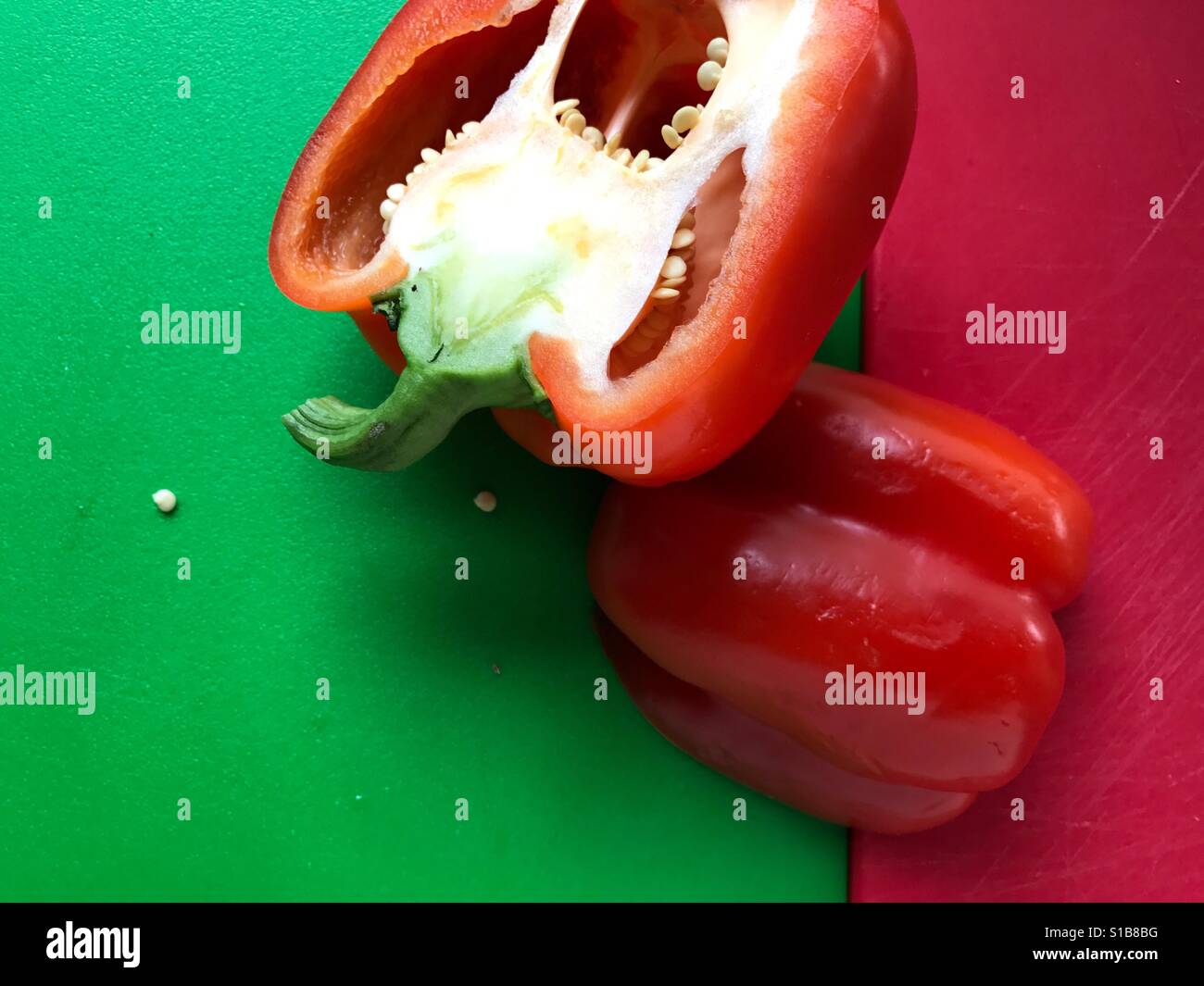 Red bell pepper on green and red Stock Photo