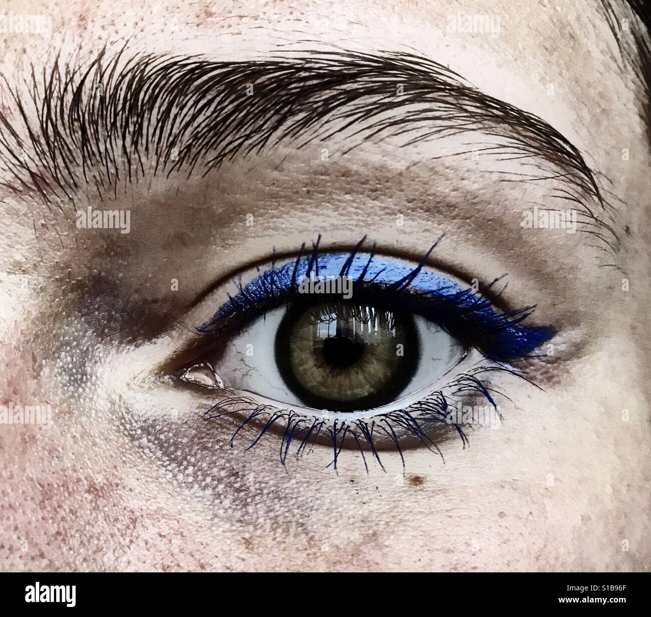 A close up of an eye with some blue eyeliner Stock Photo