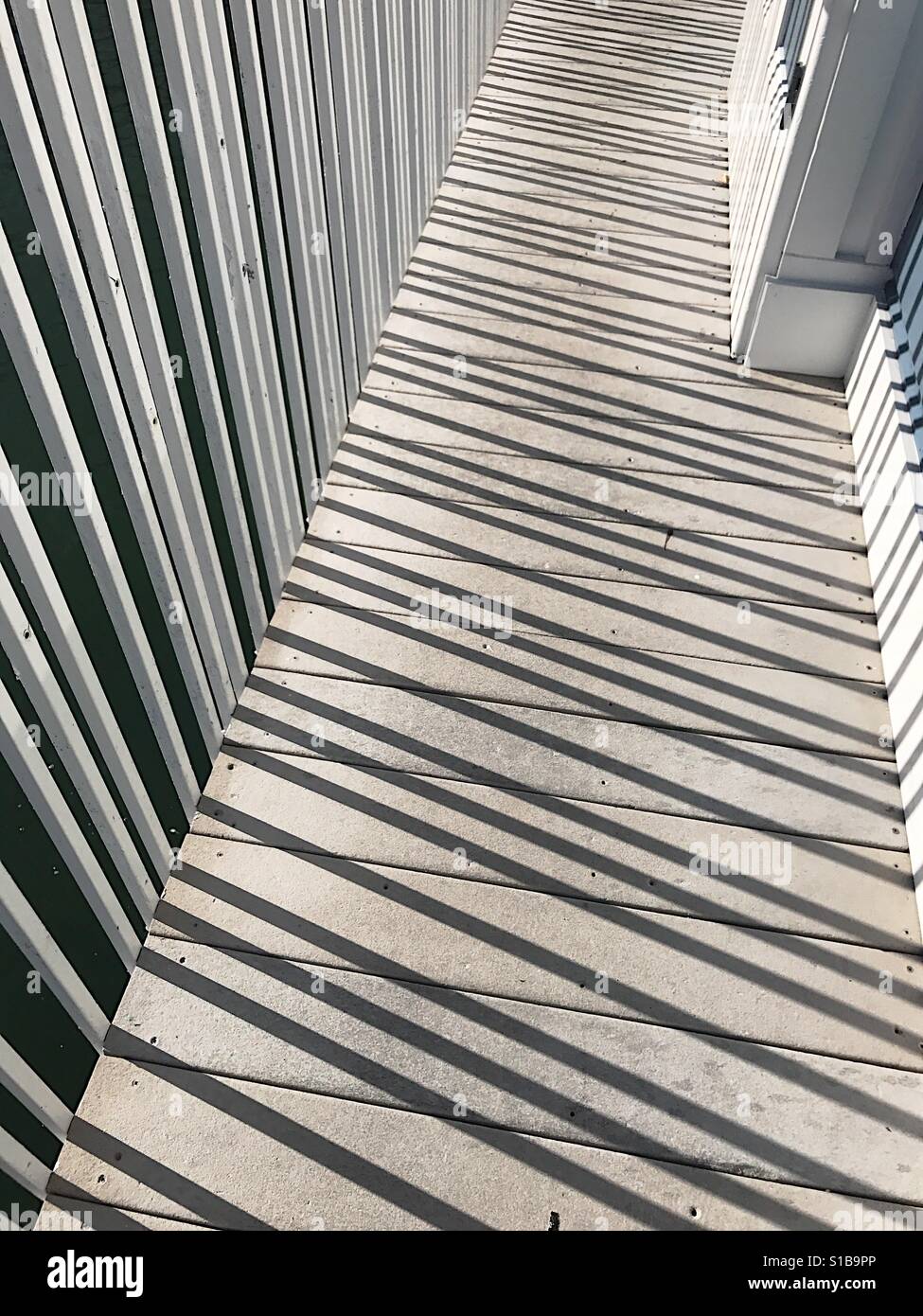 Rail shadows on walkway - Smartphone Captured Stock Image