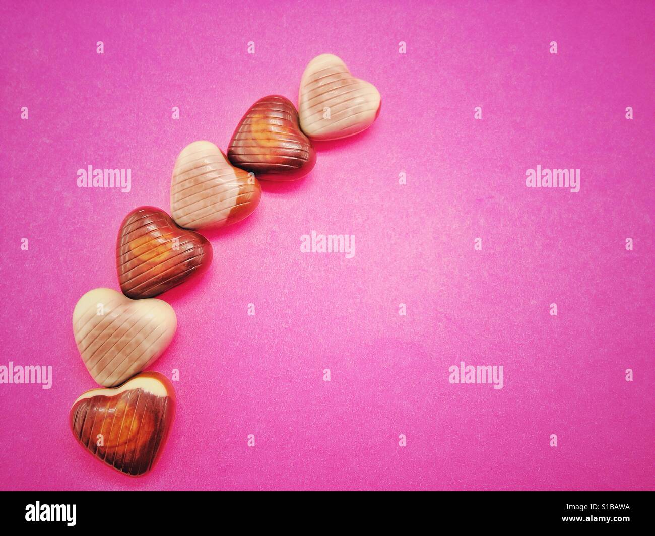 Pink background with heart shaped candies - Smartphone Captured Stock Image