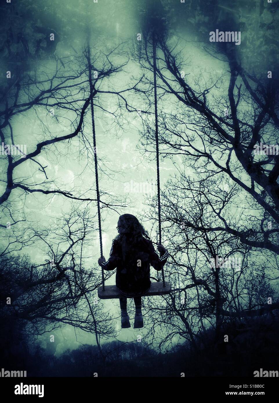 Young Girl In Swing In The Woods Stock Photo Alamy