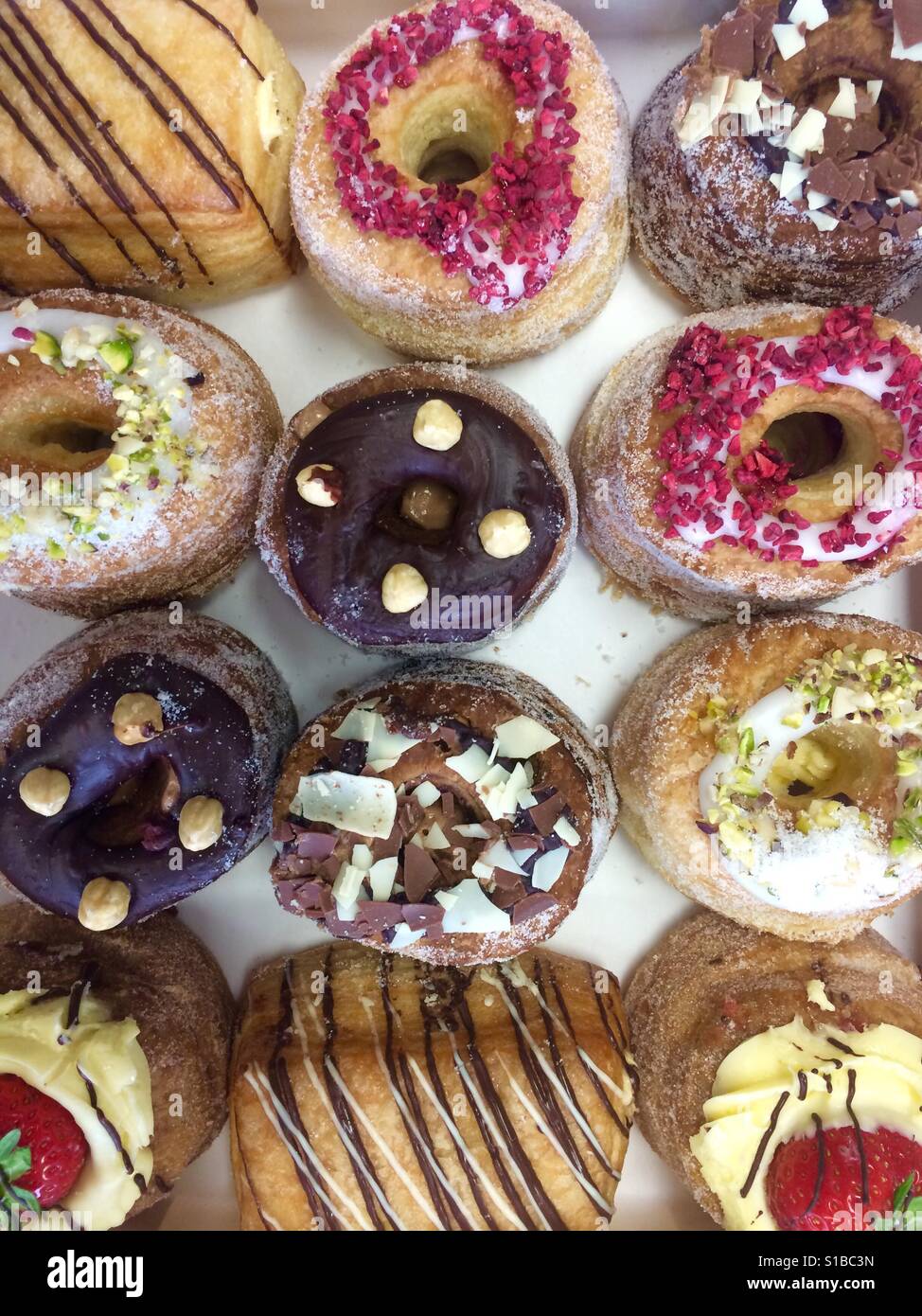 A colourful selection of cronuts in a variety of flavours Stock Photo