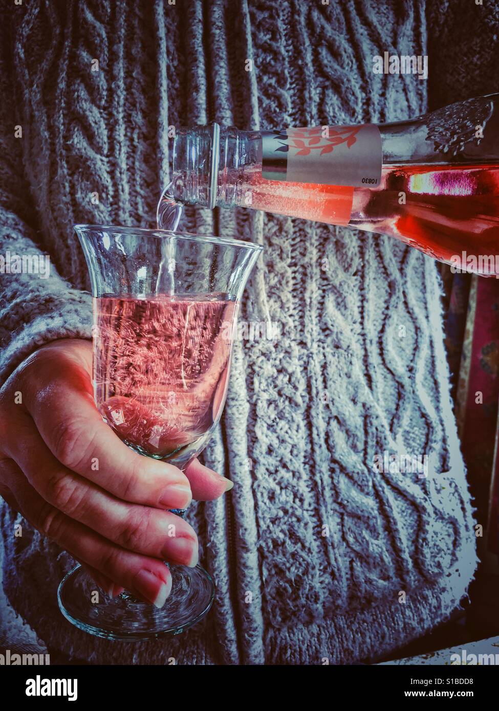 Woman pouring pink tonic in to a glass - Smartphone Captured Stock Image
