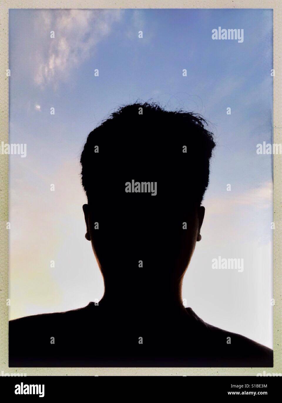 Silhouette Anonymous Man Face in Frame with Sky Background Stock Photo