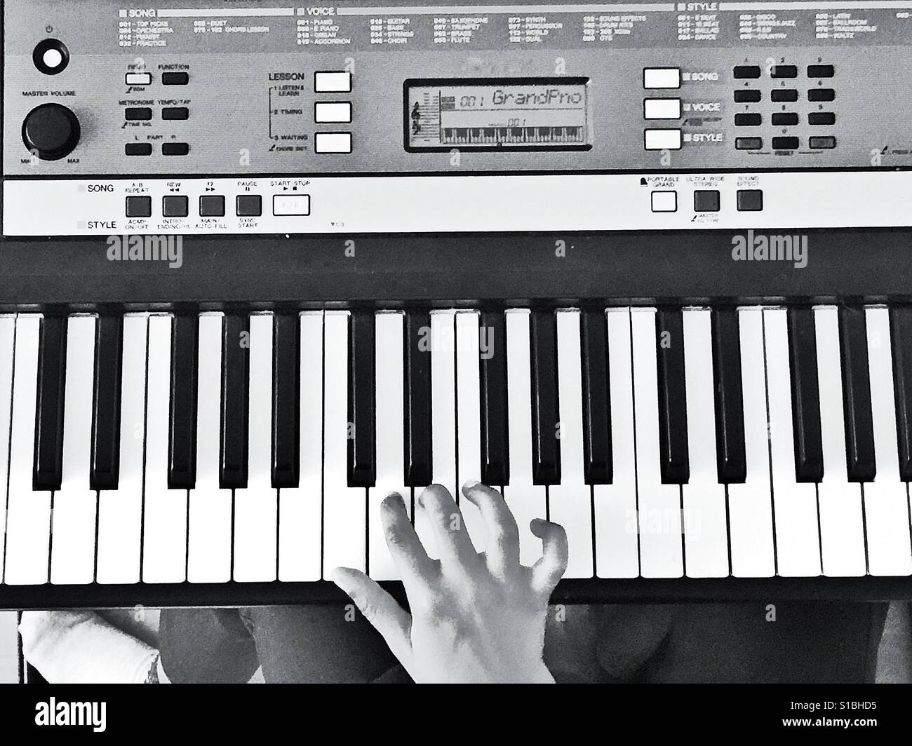 A child's hand on a keyboard. - Smartphone Captured Stock Image