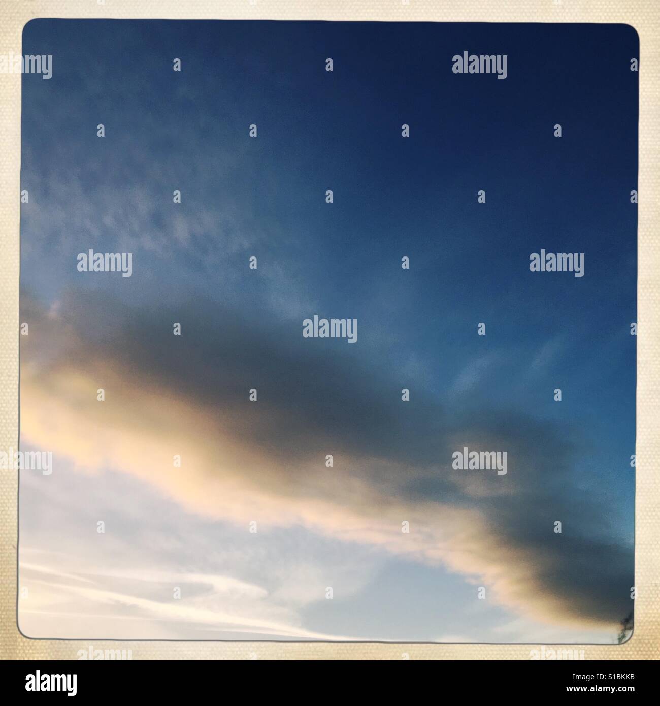 Angry looking cloud in a blue sky - Smartphone Captured Stock Image