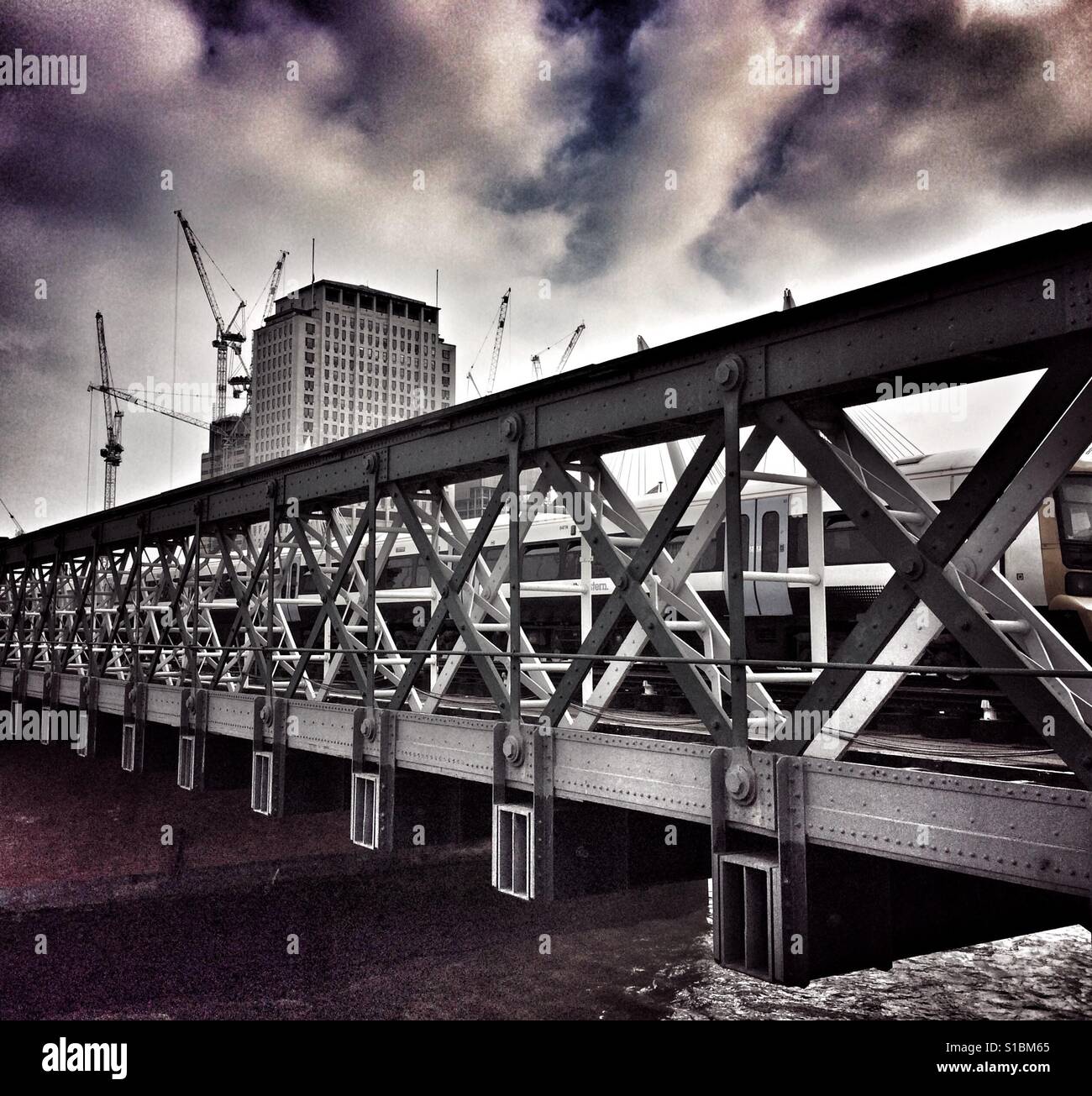 Hungerford railway bridge with train crossing - Smartphone Captured Stock Image