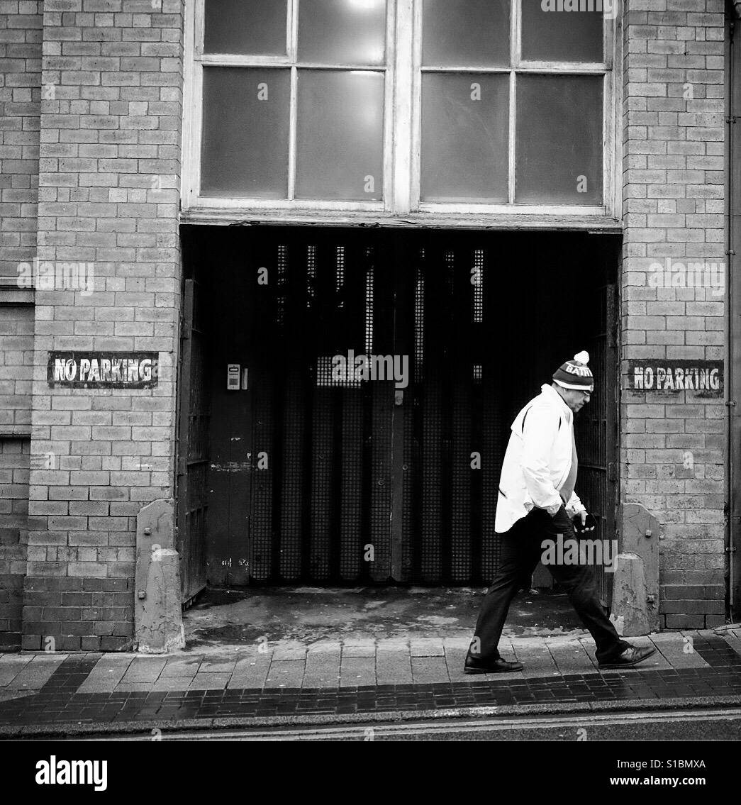 Man walking purposely up a street in Leeds, West Yorkshire. Uk - Smartphone Captured Stock Image