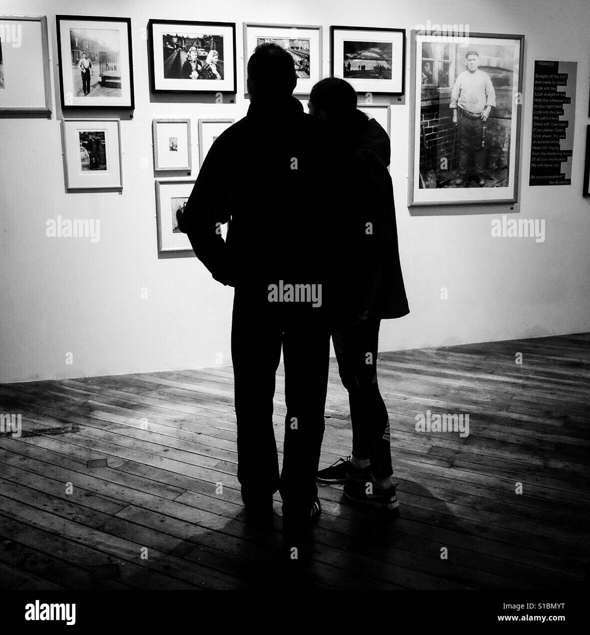 A couple enjoying art in a Gallery on display at Bradford Industrial Museum. - Smartphone Captured Stock Image