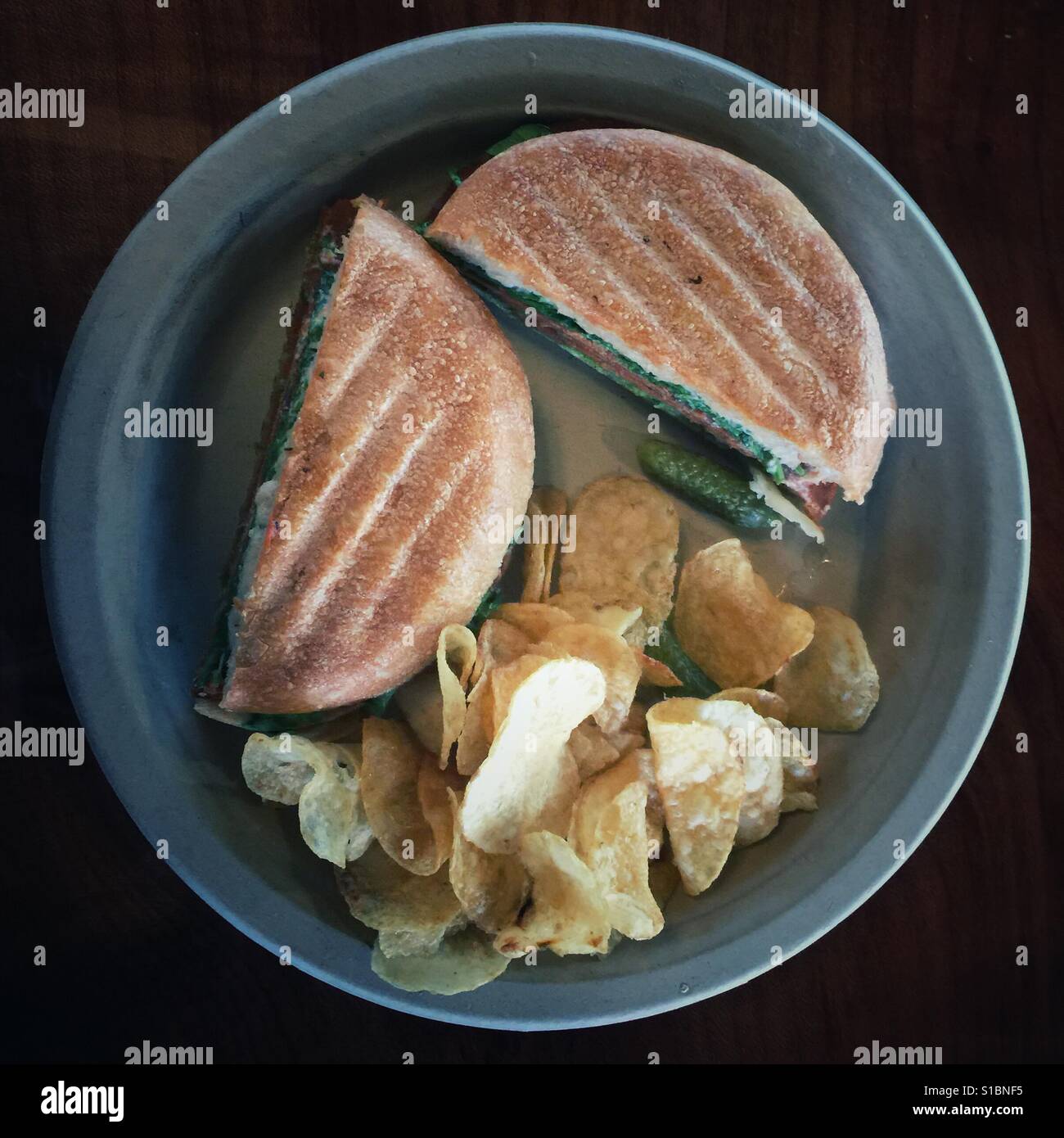 Grilled sandwich and potato crisps on a plate - Smartphone Captured Stock Image