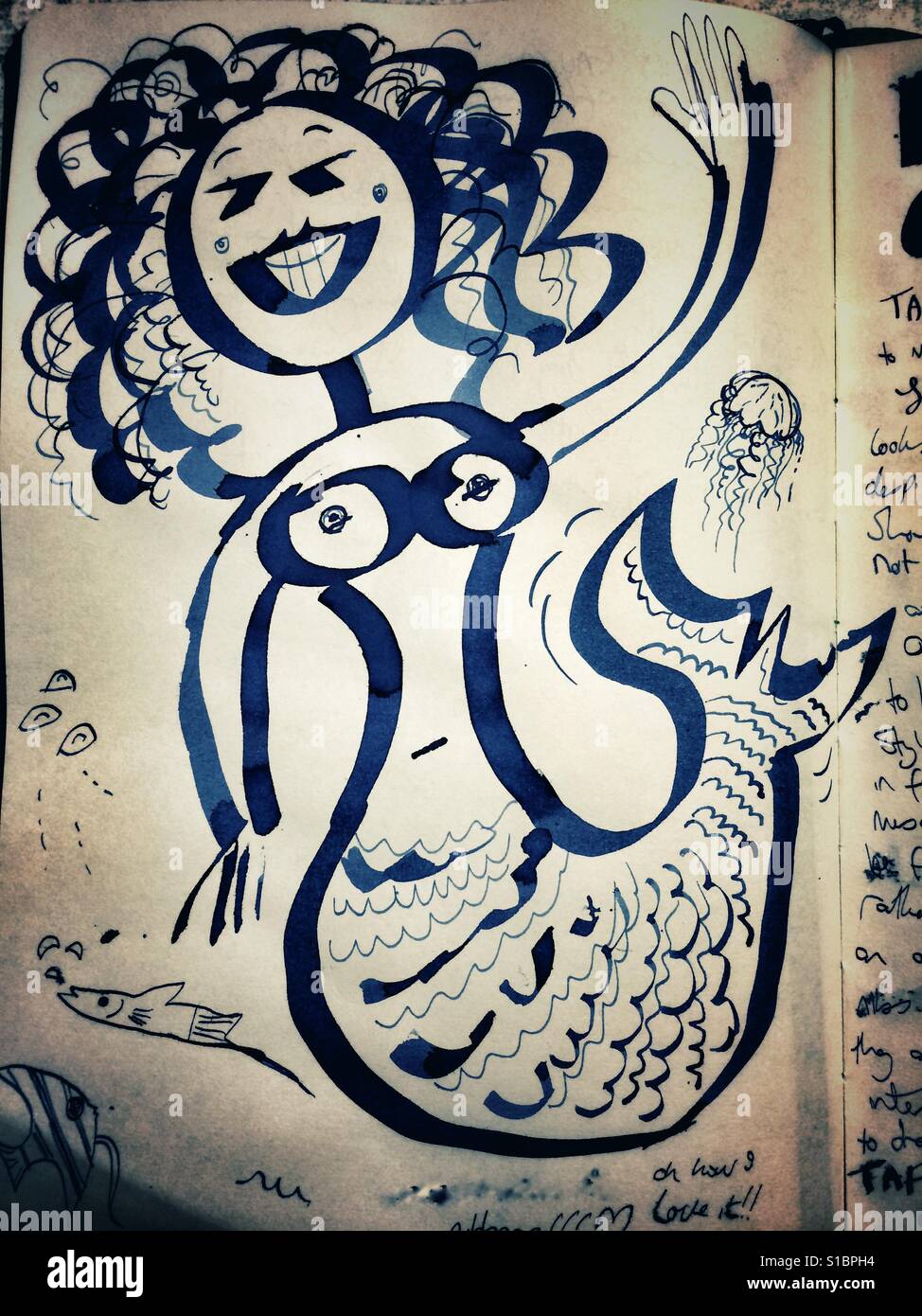 A page from a sketchbook with a funny illustration of a mermaid - Smartphone Captured Stock Image