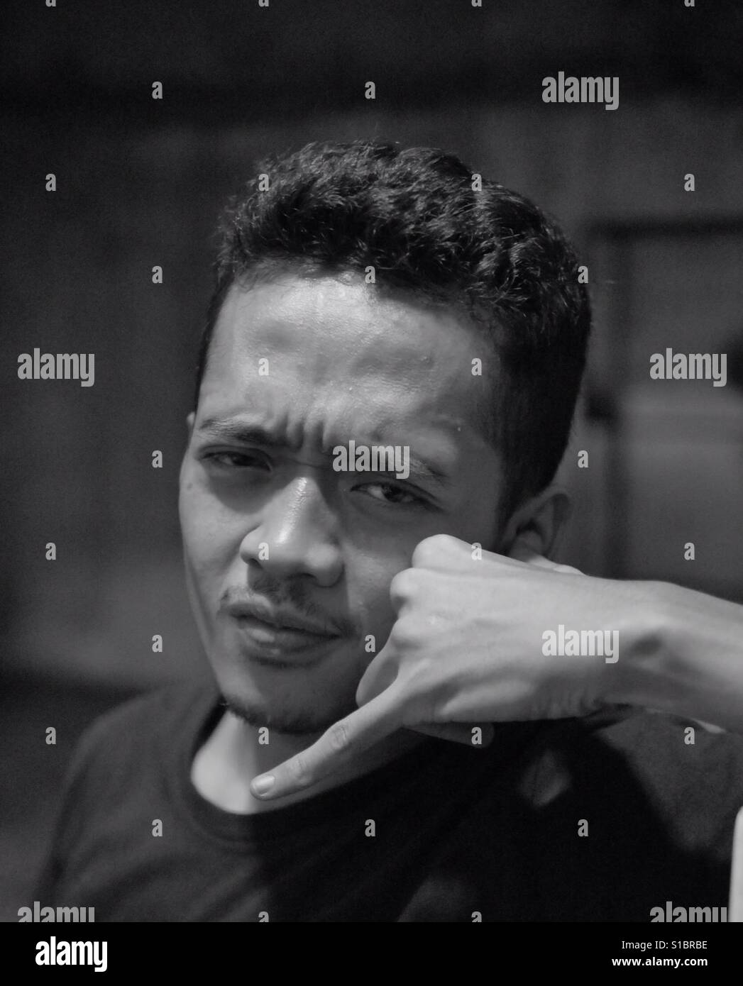 Man with Call Me Sign in Black and White Stock Photo - Alamy