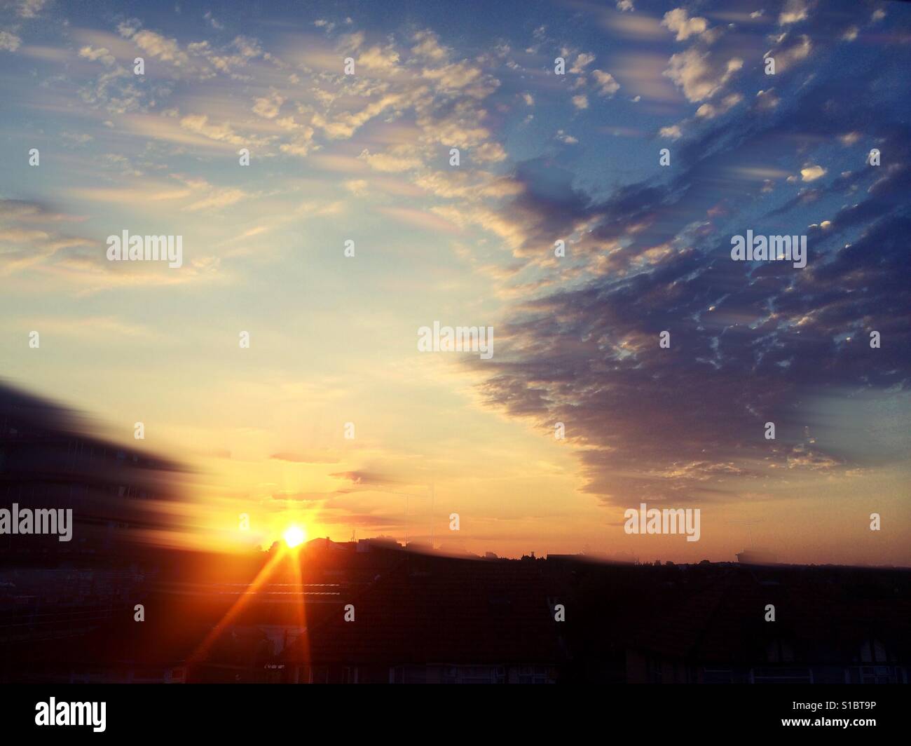 Early Evening Sunset In A Cloudy Sky With Motion Blur Of The Stock Photo Alamy