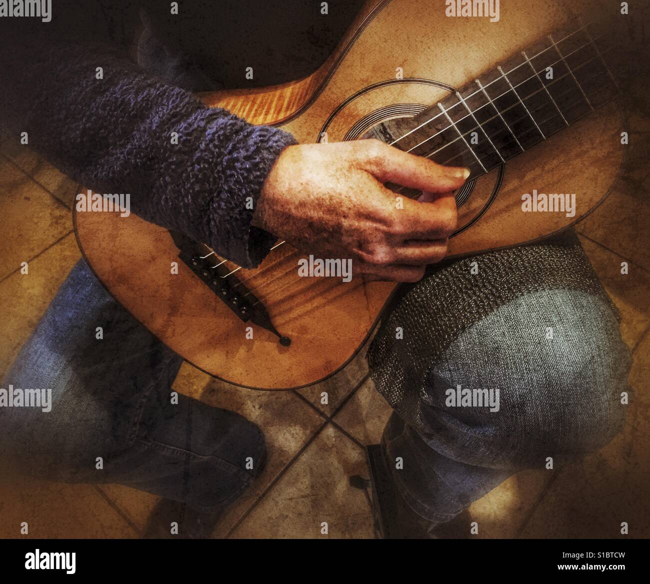 Musician playing a replica of a 19th century Panormo Fecit guitar, close up - Smartphone Captured Stock Image