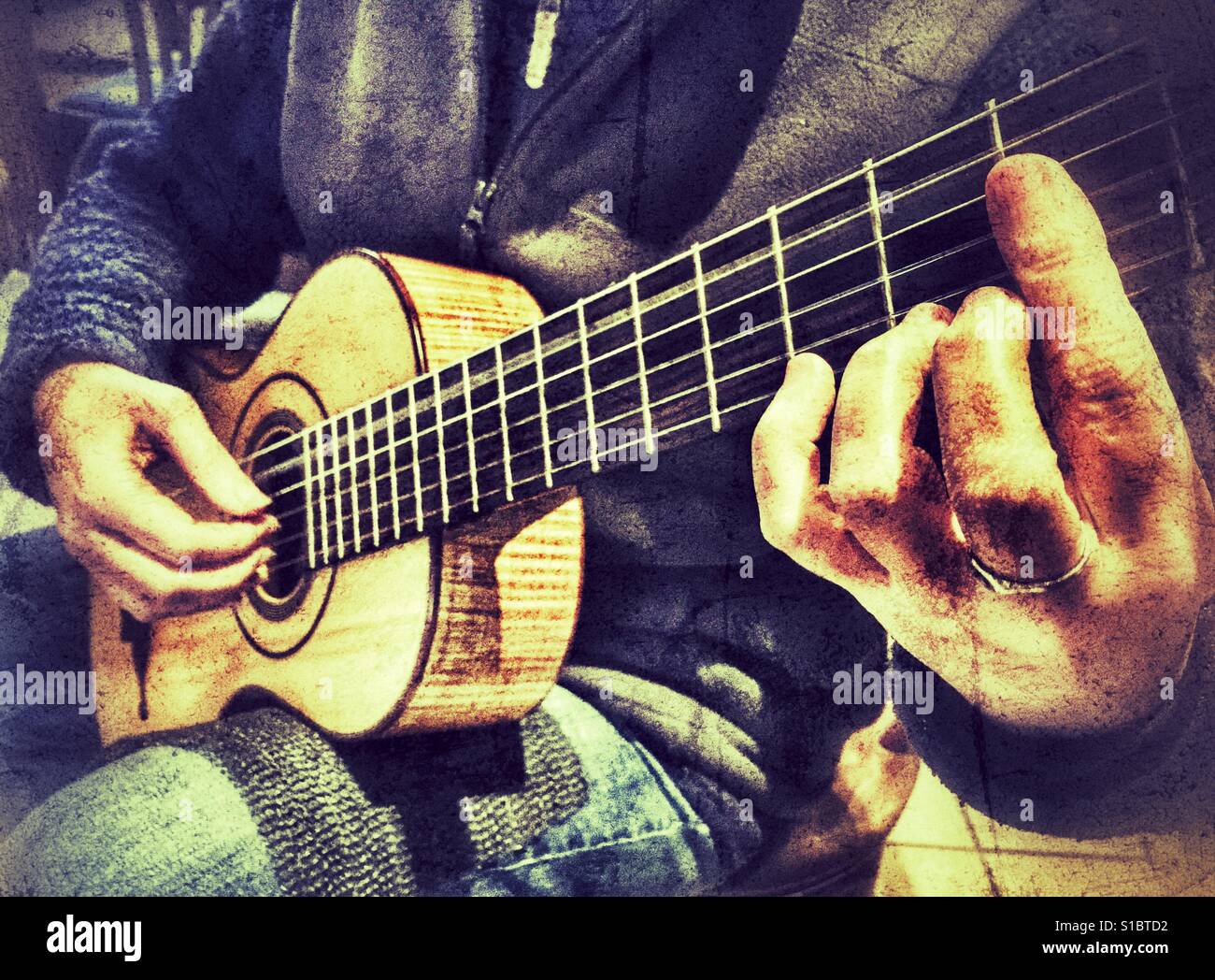 Close up of woman playing a replica of a 19th century Panormo Fecit guitar - Smartphone Captured Stock Image