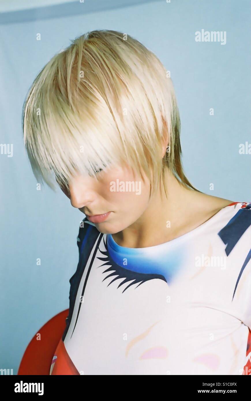 Blonde girl closed eye top looking through hair - Smartphone Captured Stock Image