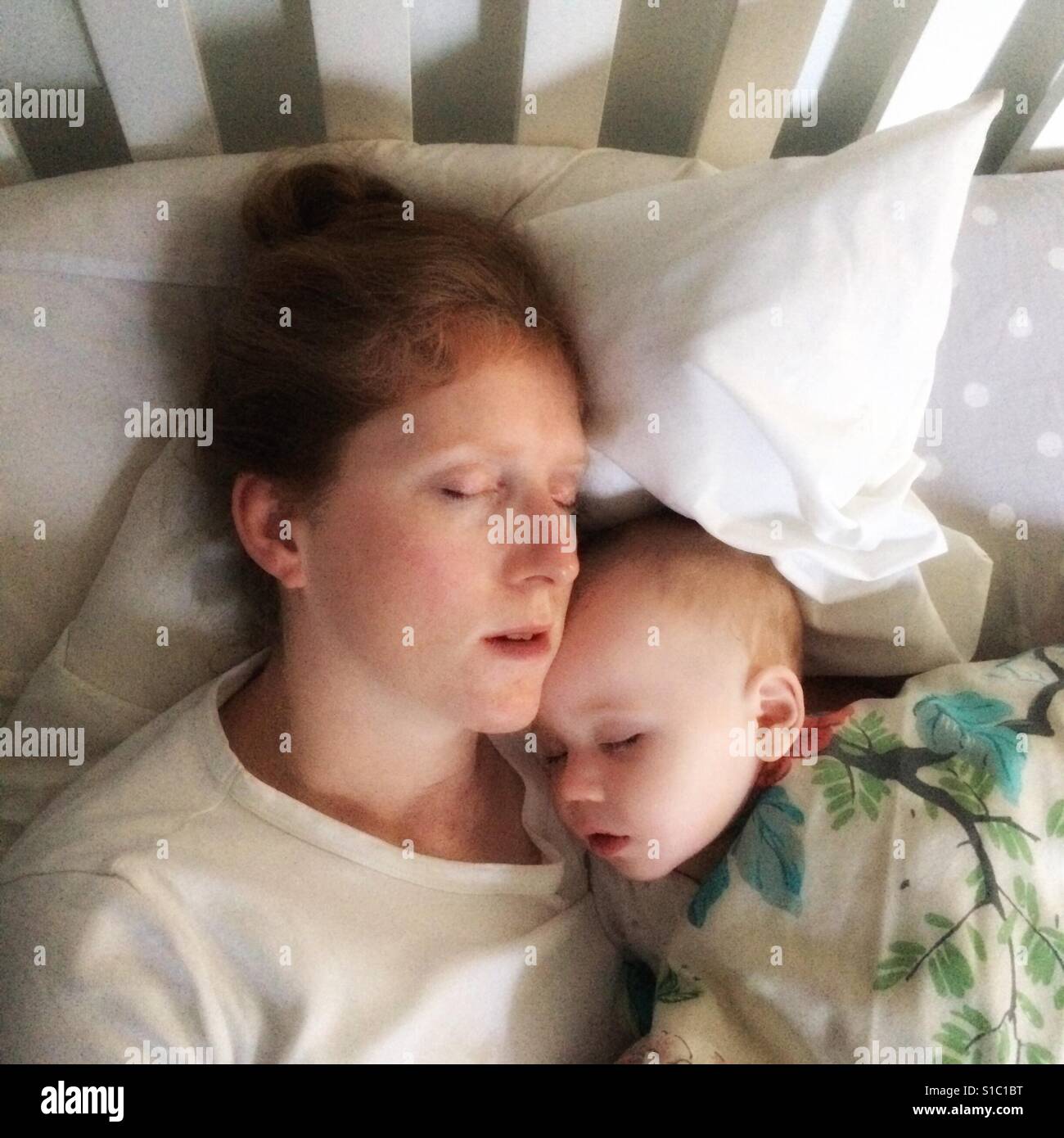 Sleeping mother and baby boy - Smartphone Captured Stock Image