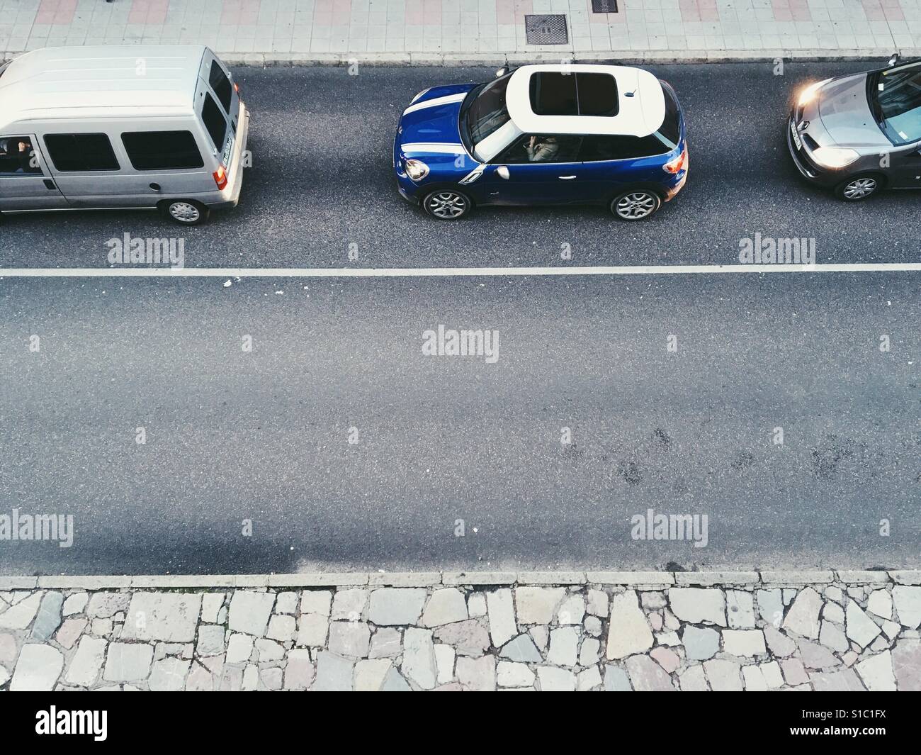 View from above of a line of stationary cars and an empty lane Stock Photo