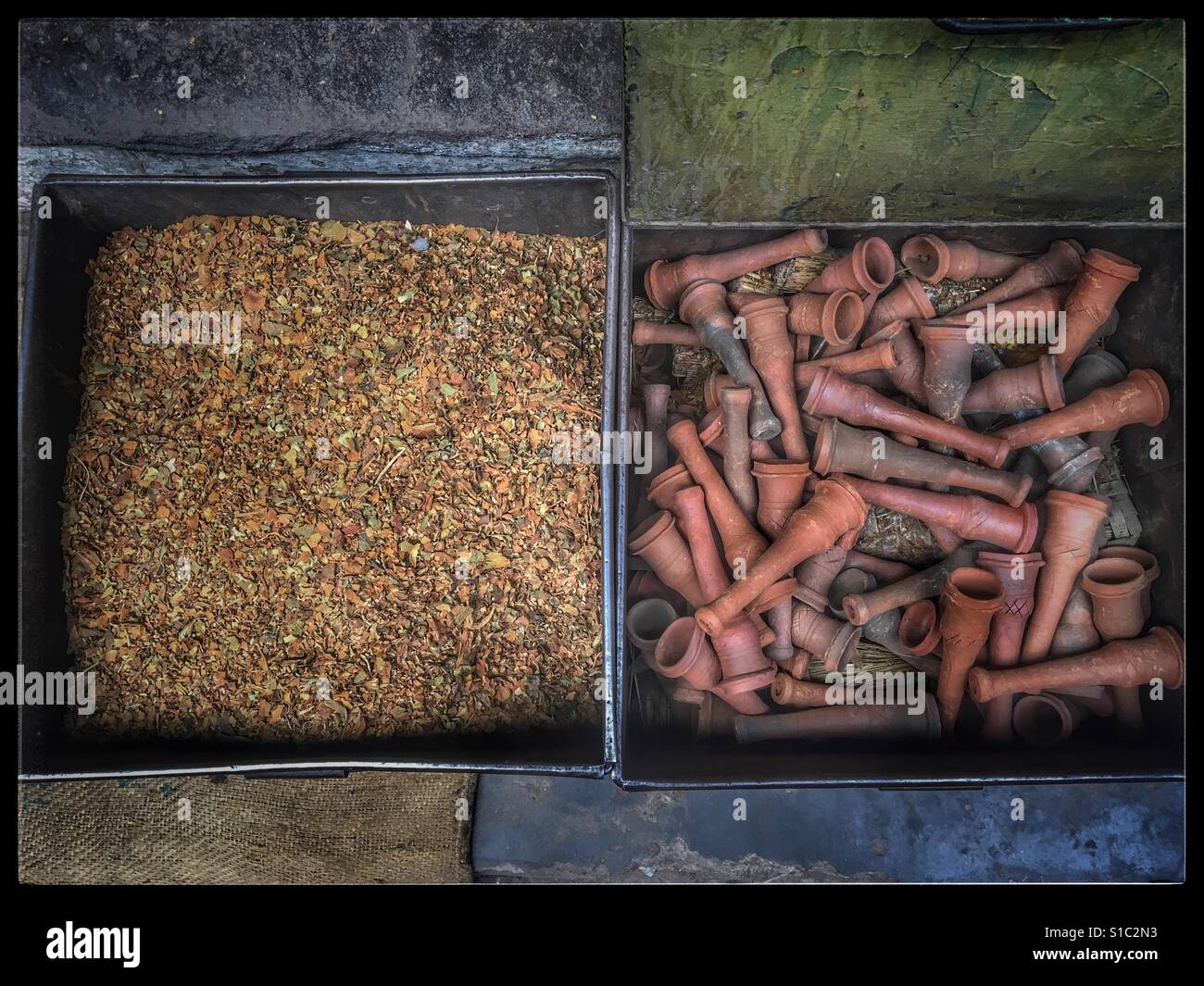 Tobacco with clay pipe are used for smoking traditionally in india. It's still widely used in rural places of India. - Smartphone Captured Stock Image