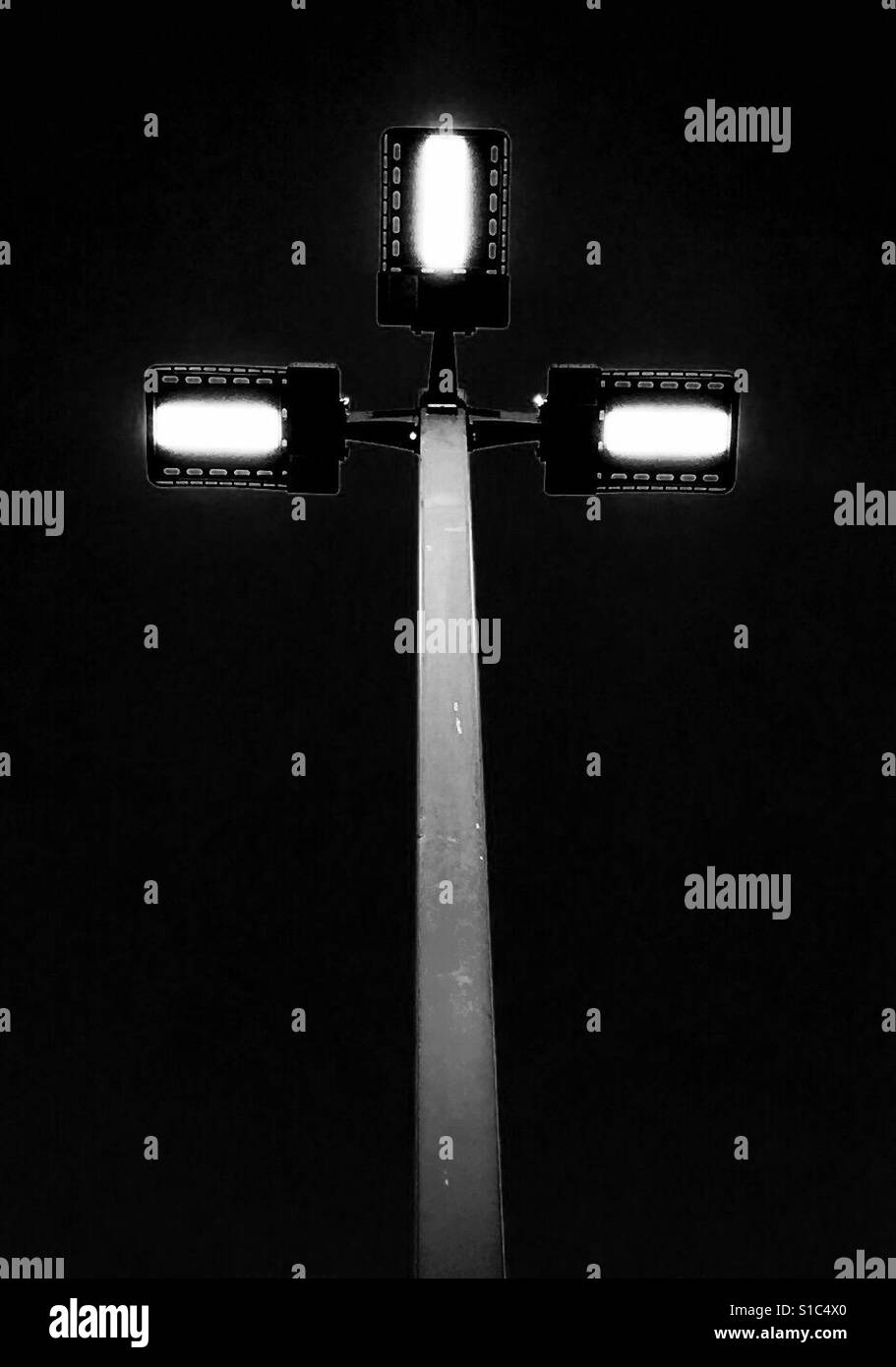 Modern, abstract fluorescent lamp light on rooftop of parking lot black and white Stock Photo