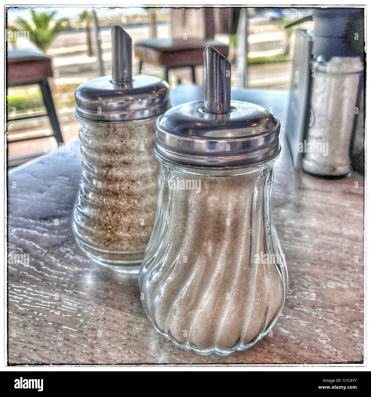 White and brown sugar shakers in restaurant table Stock Photo Alamy