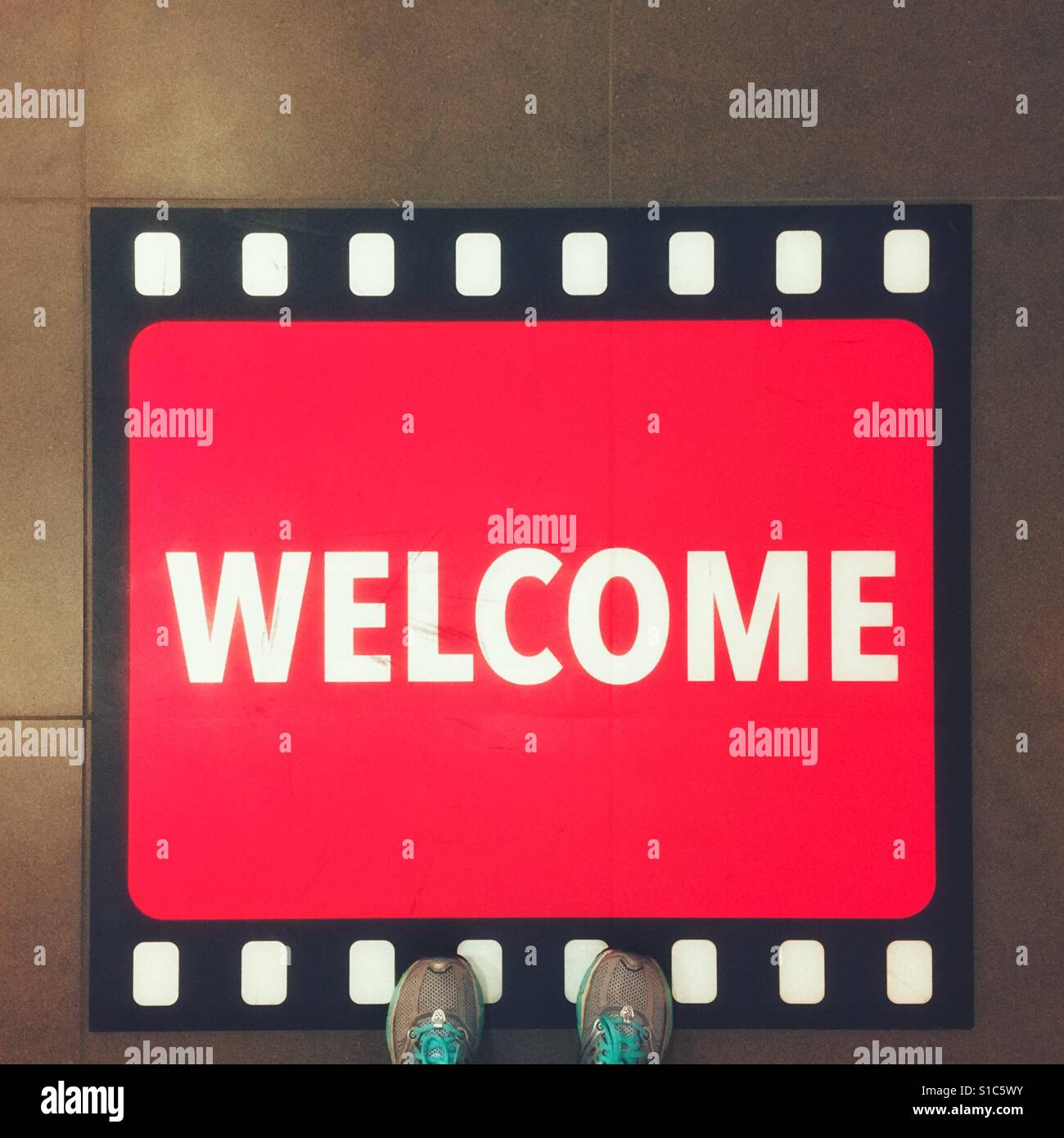 Pair of shoes and welcome sign - Smartphone Captured Stock Image