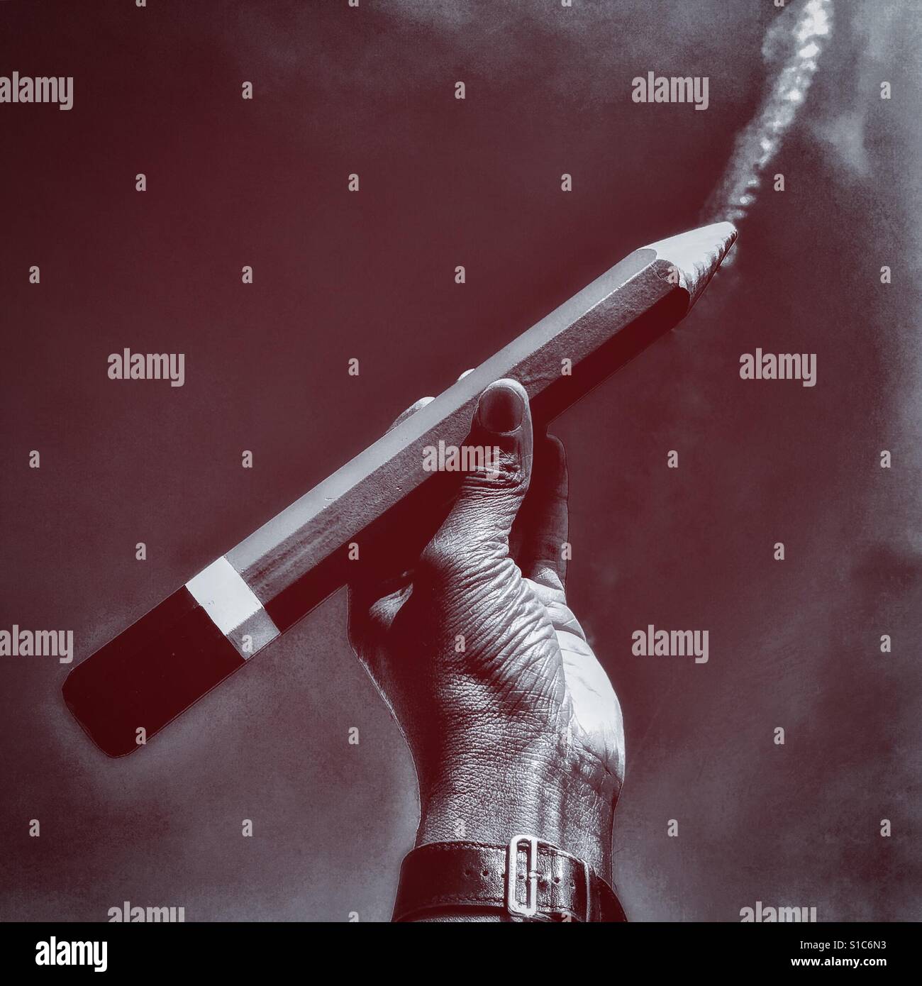 Hand with a giant pencil against the sky. - Smartphone Captured Stock Image