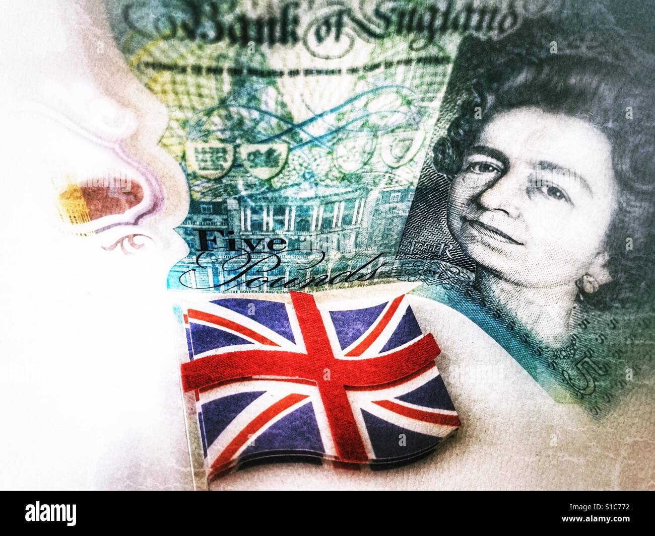 English £5 note standing on its edge behind a Union Jack flag - Smartphone Captured Stock Image