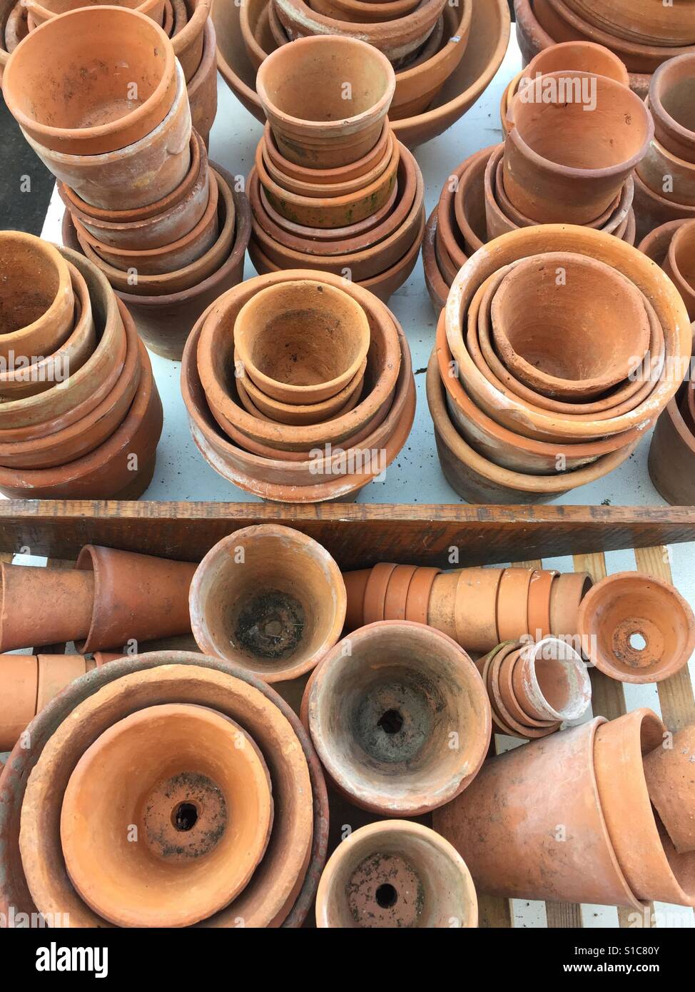 Selection of vintage terracotta gardening pots for sale in a market stall, England Stock Photo
